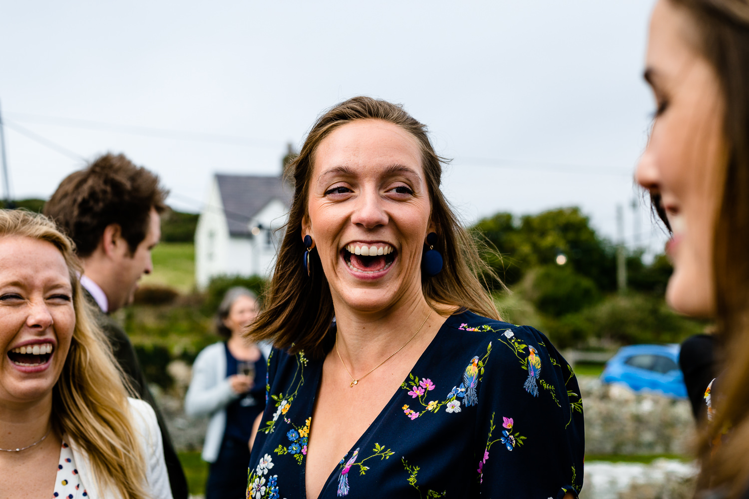 Laughing guests, relaxed Anglesey wedding photographers