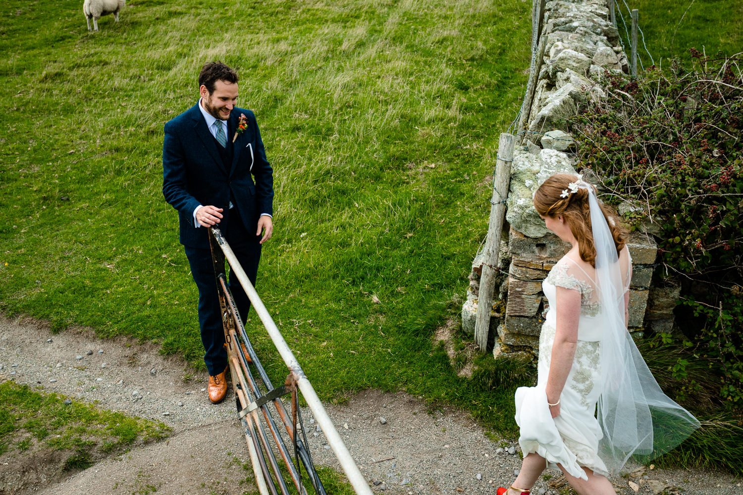 A newly married couple explore the headland, wedding photography Anglesey