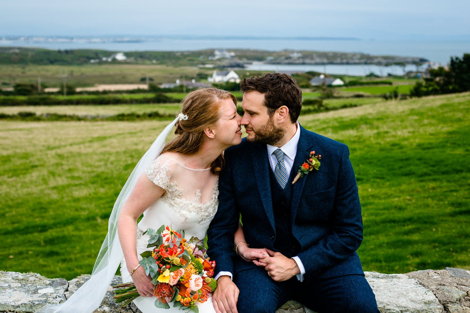 A cute moment between a bride and groom Anglesey wedding photos