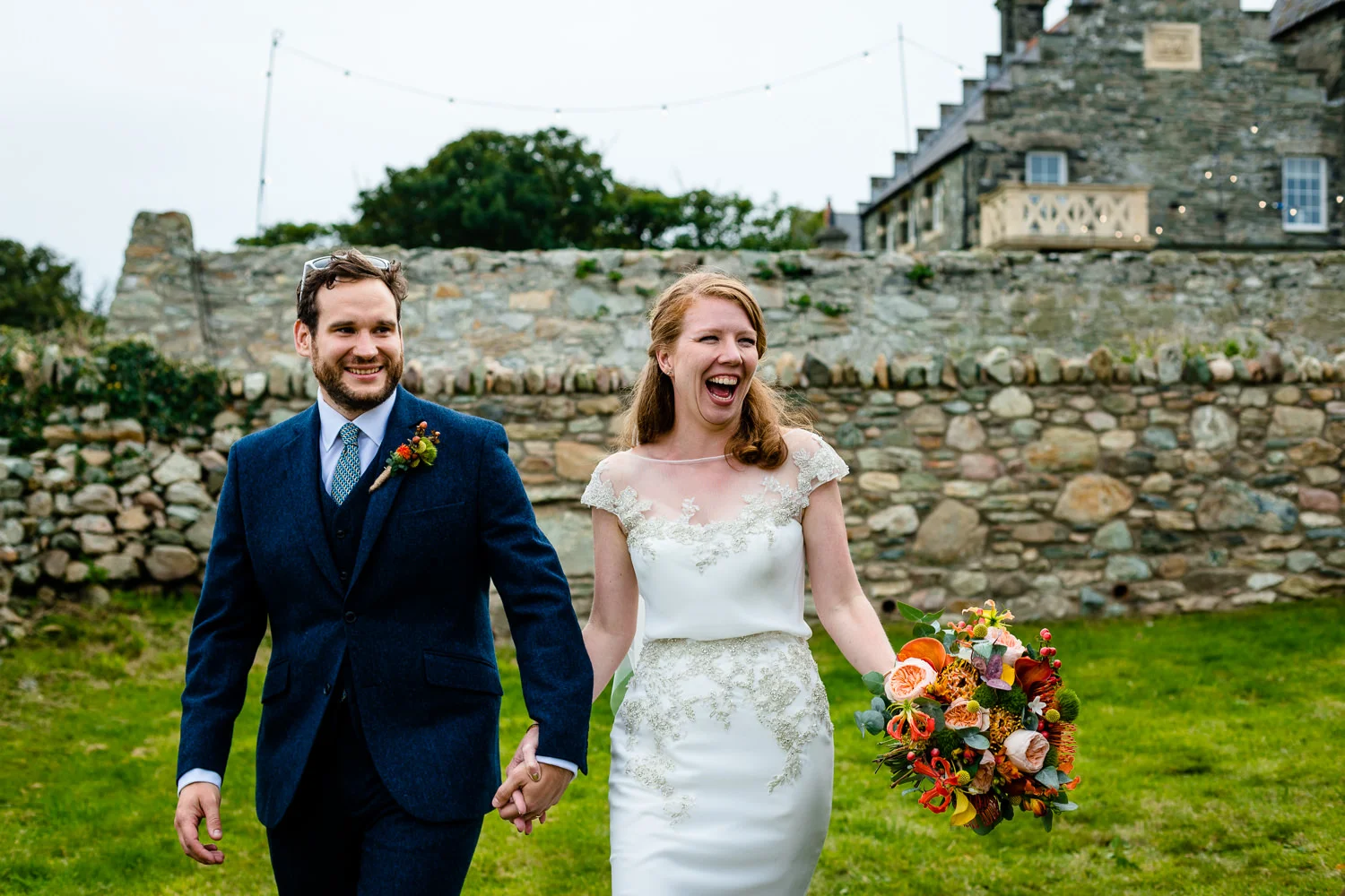 A bride and groom making their entrance to their tipi reception Anglesey wedding photo