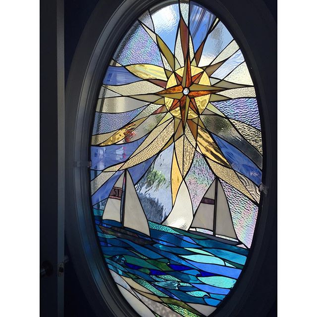  Custom oval compass rose sun complete and installed in door frame. 
