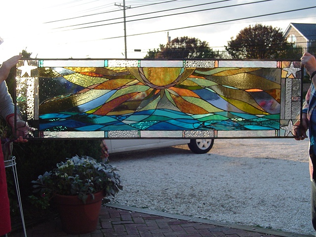  Sunrise Over Brigantine  Stained Glass  This is a view of the transom window prior to installation. The rich turquoise and warm golden yellows provide an inviting accent to the entryway of this private residence.  This piece is now held in the Schim