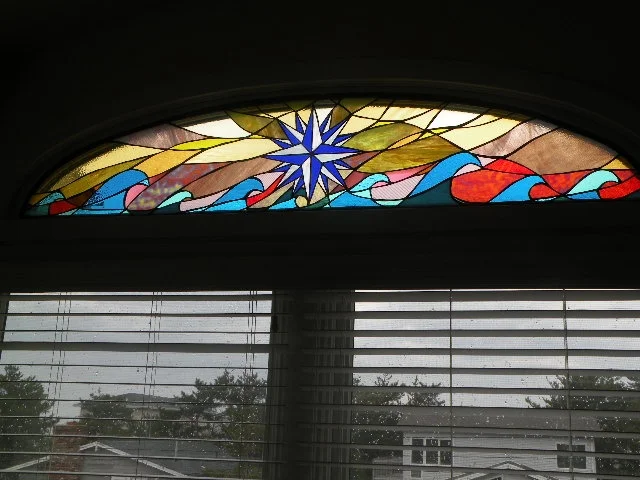 Compass Rose of Cedars stained glass 61" x 17" The compass rose is a tool used by ancient mariners to navigate the stormy and calm seas to find faraway lands and then guides them safely back home.