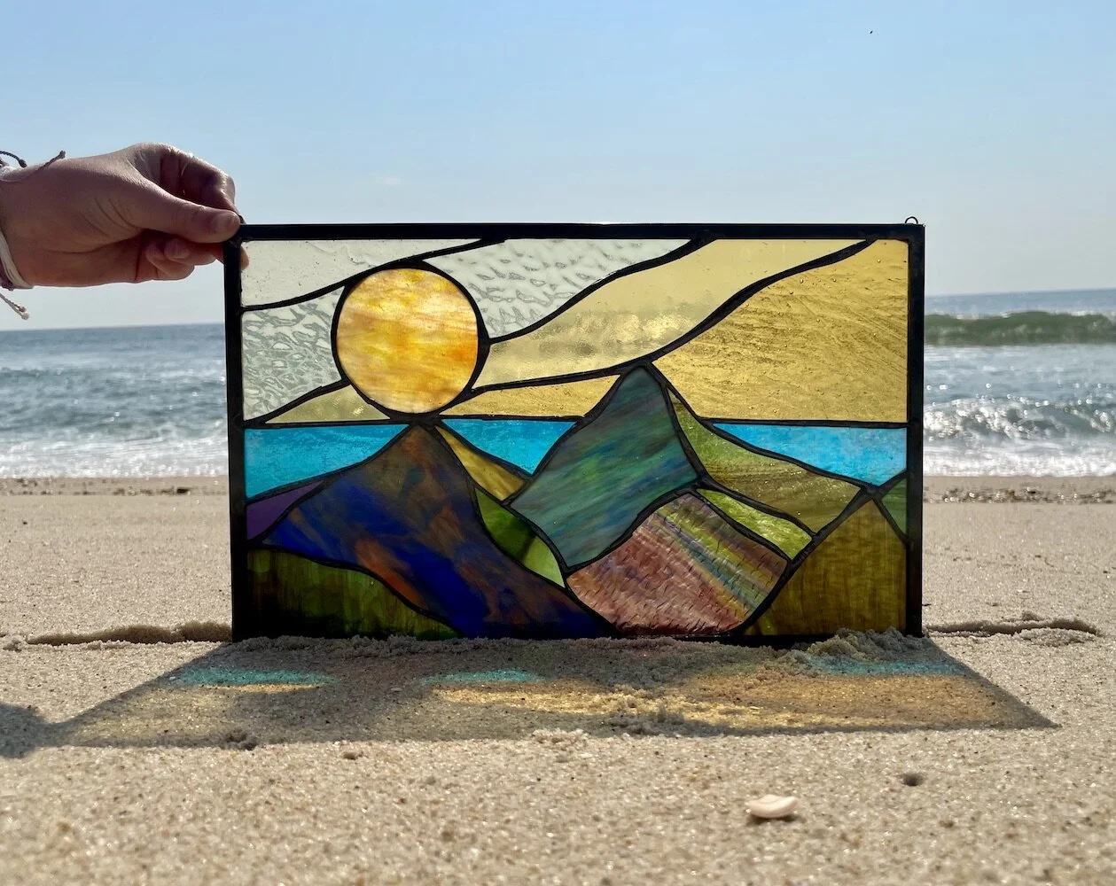 sunset over mountain lake stained glass