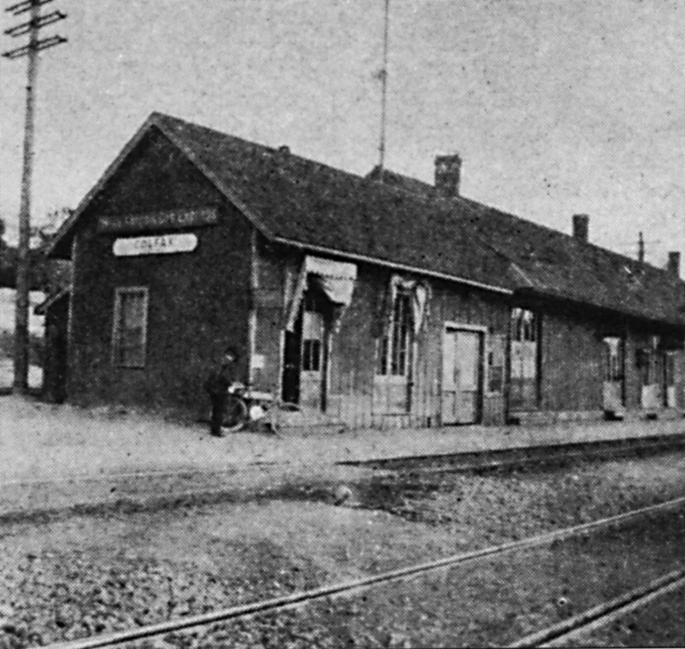 Wyman's photograph of at the Colfax Depot, near the Donner Summit with his bike leaned against the station.
