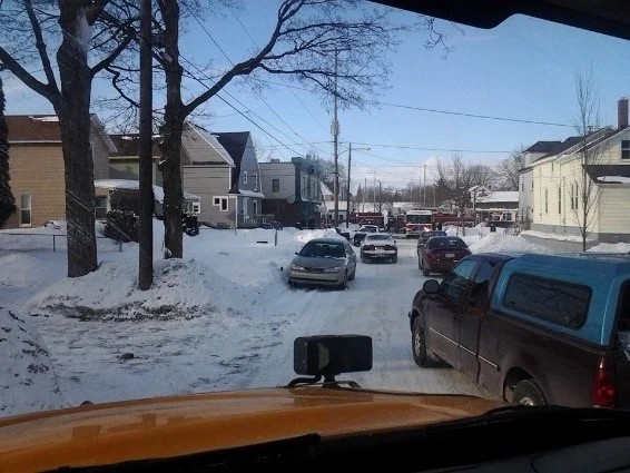This photo was taken by resident Luci Anderson of Fire Trucks that were unable to respond quickly to a business fire (Sam's Party Store) on 2/27/2014 due to cars being parked on both sides of the street.