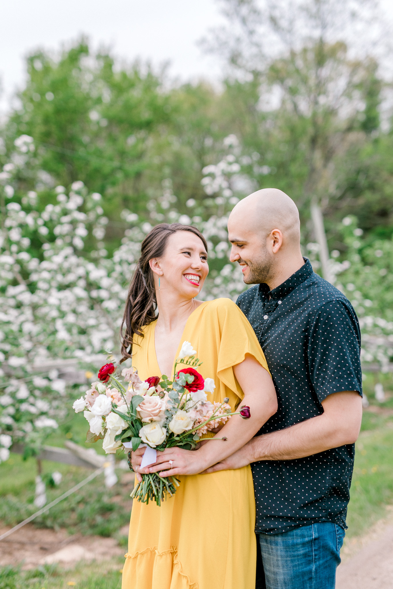 Spring Apple Blossom Engagement Session at the Orchard | Engagement Bouquet | Mustard Yellow Dress | What to Wear to Your Engagement Session | Grand Rapids Wedding Photographer