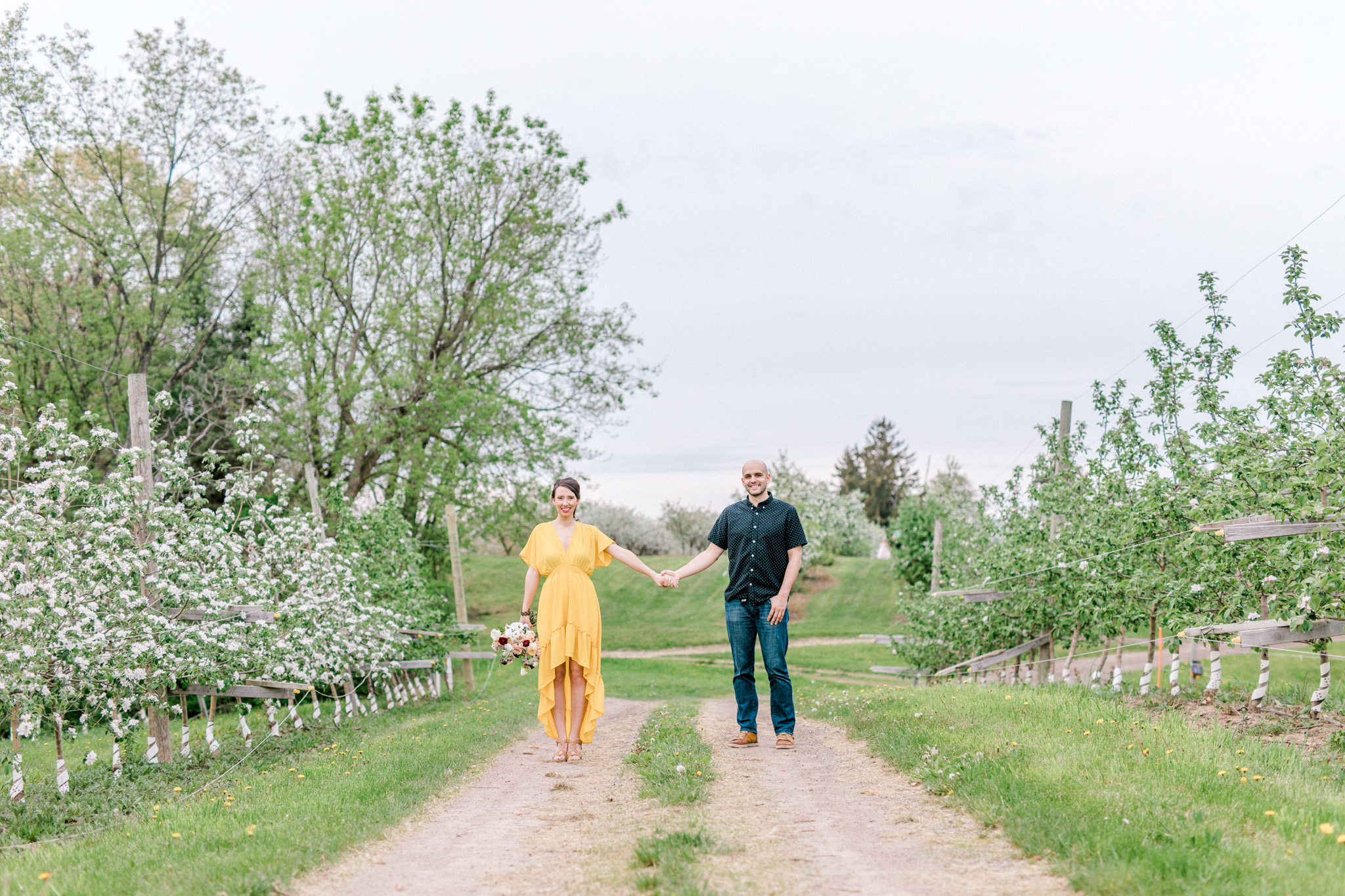 Spring Apple Blossom Engagement Session at the Orchard | Engagement Bouquet | Mustard Yellow Dress | What to Wear to Your Engagement Session | Grand Rapids Wedding Photographer