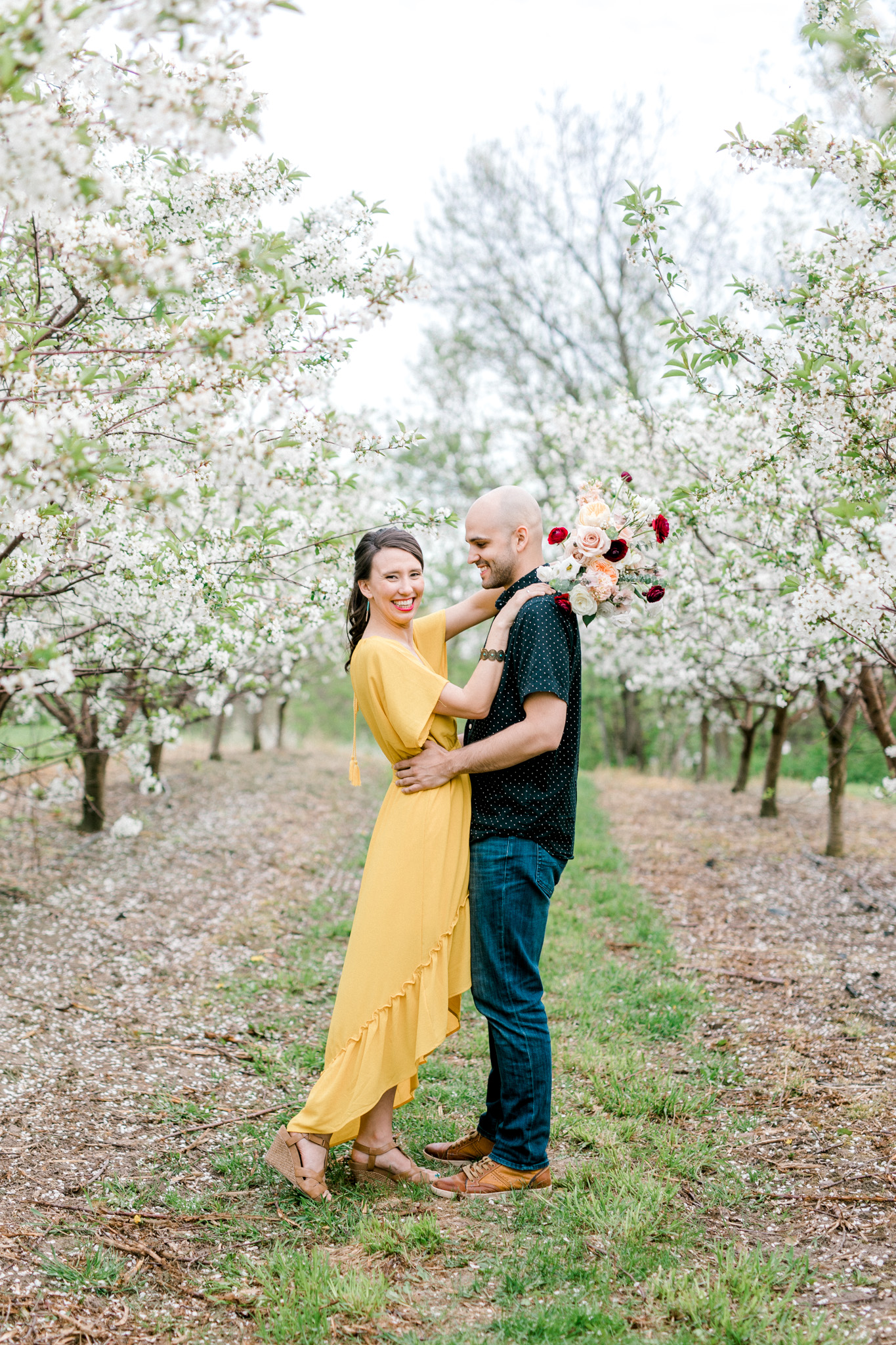 Spring Apple Blossom Engagement Session at the Orchard | Engagement Bouquet | Mustard Yellow Dress | What to Wear to Your Engagement Session | Grand Rapids Wedding Photographer