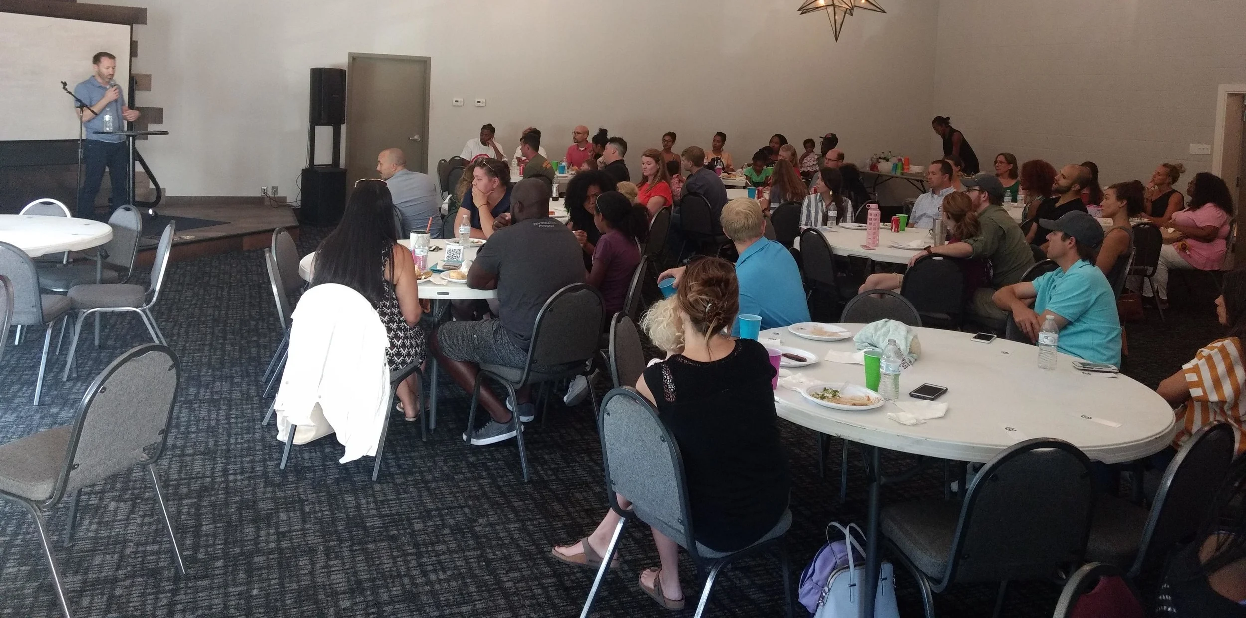 Derek Carson discussing multi-ethnicity with the gathering.