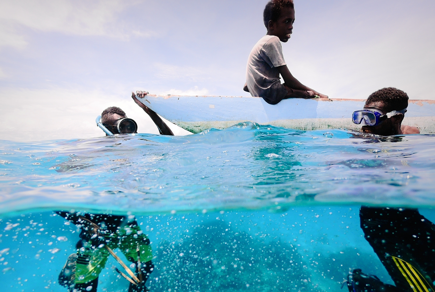 Carteret Island boys fishing. Warmer waters mean less coral and fewer fish. Malnutrition is an concern.
