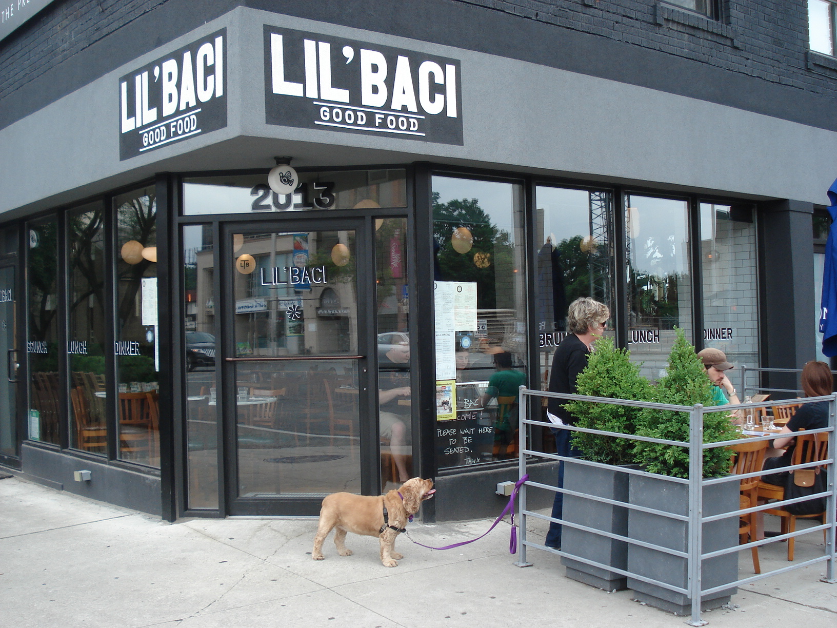 Picture of accessible entrance. Dog tied to outdoor pole