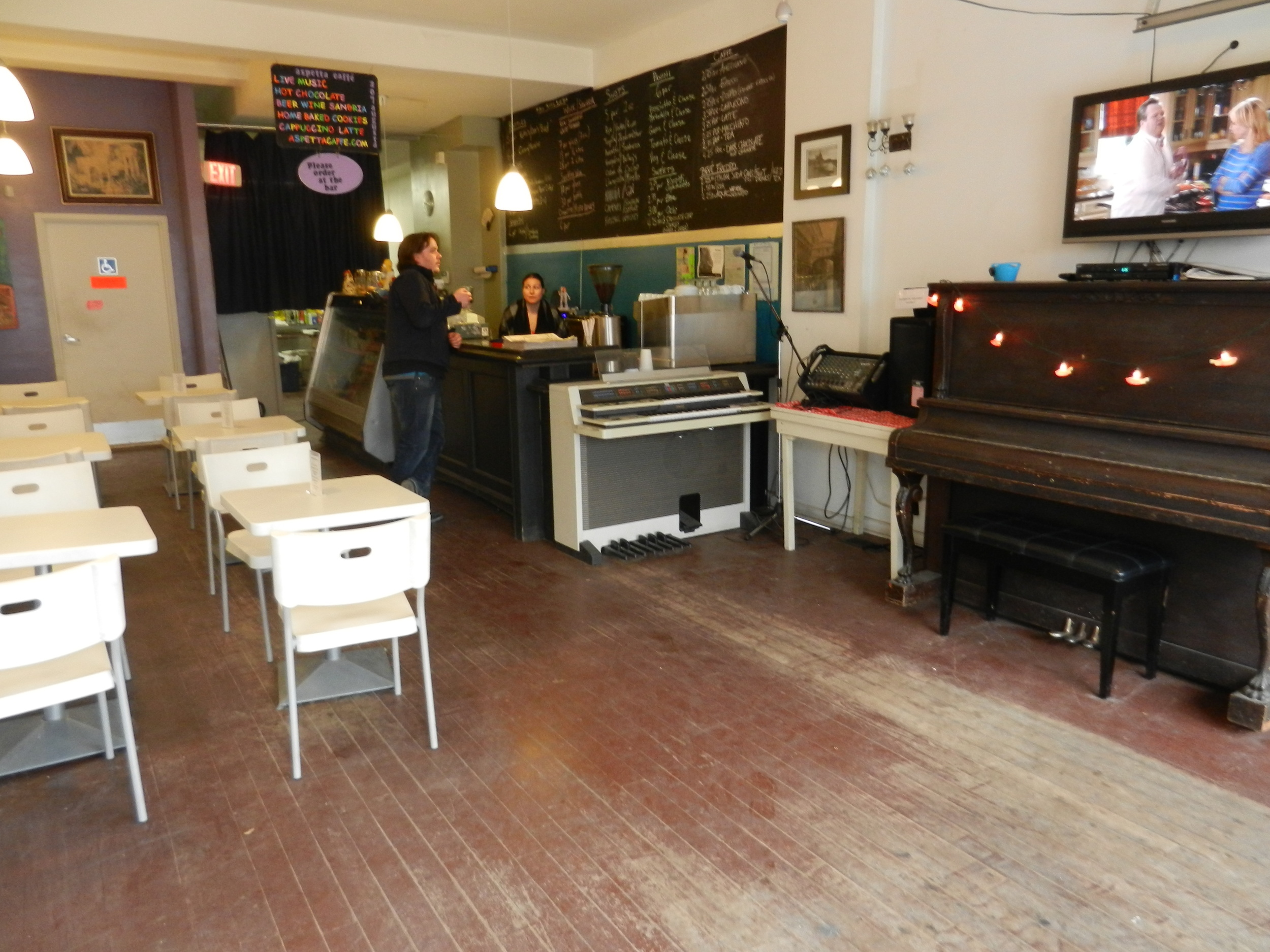 Picture of accessible indoor seating area and piano.
