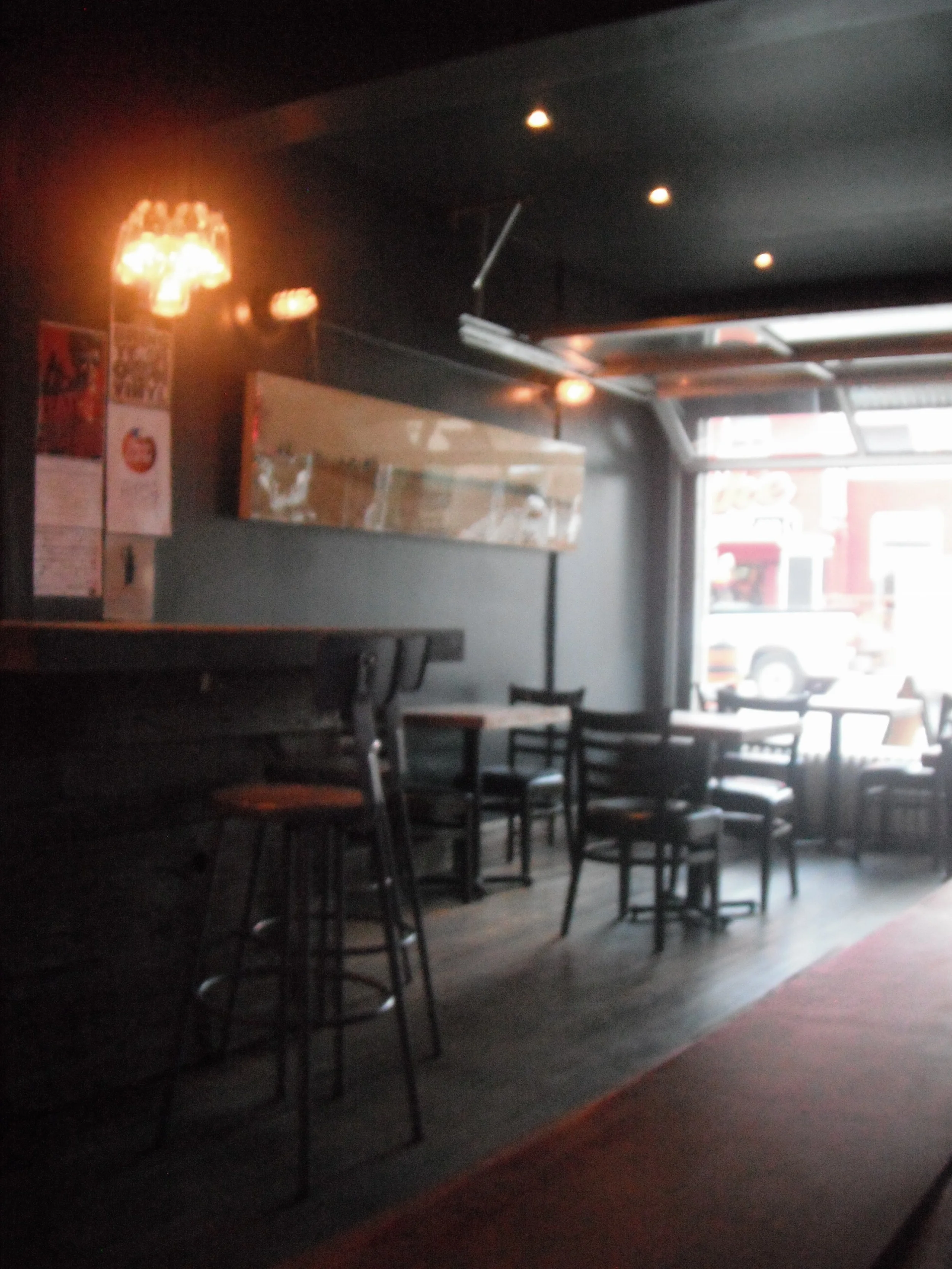 Picture of accessible interior of bar. Level floors, standard height tables.