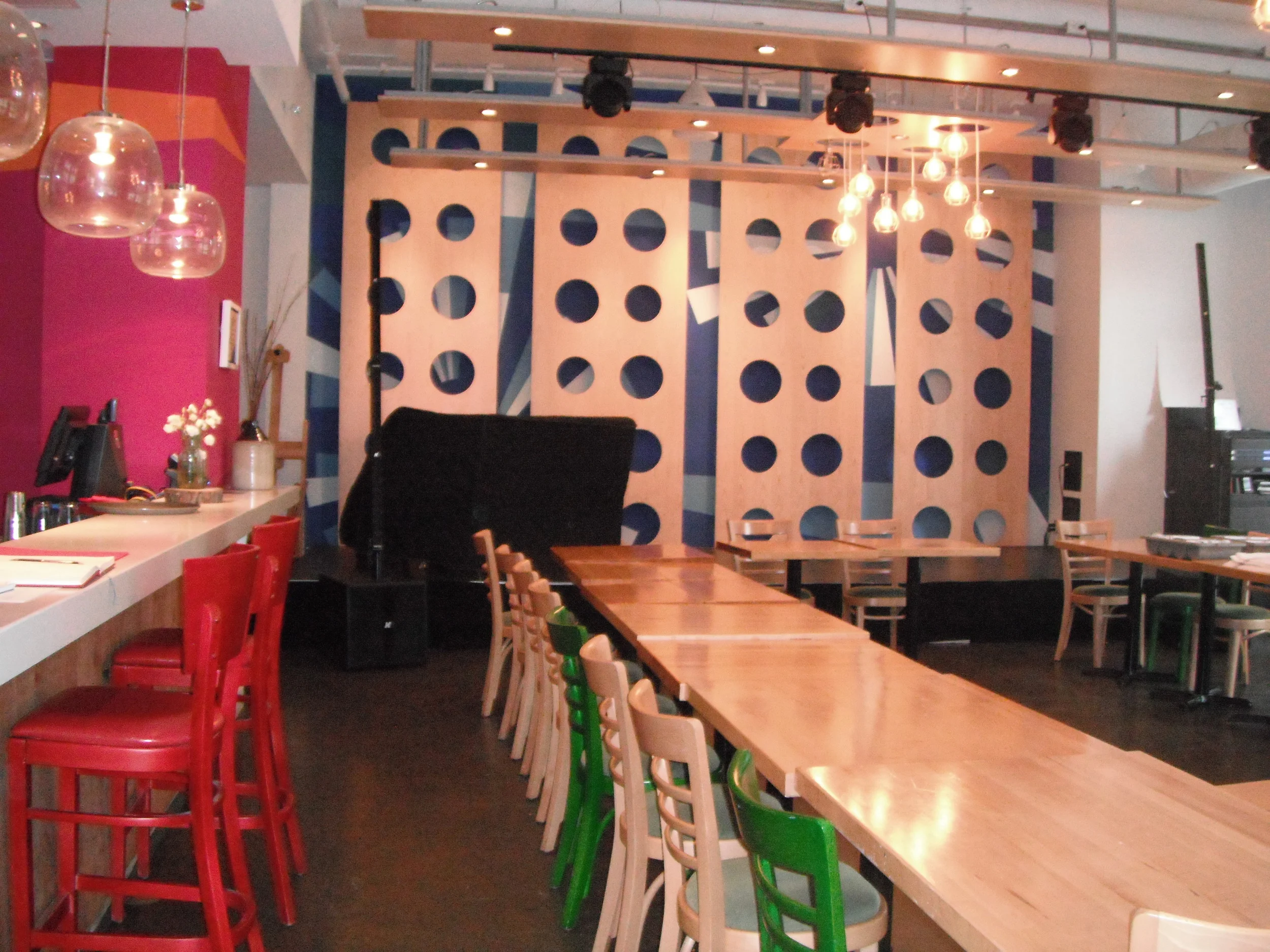 Picture of interior bar with stools as well as standard height dining tables