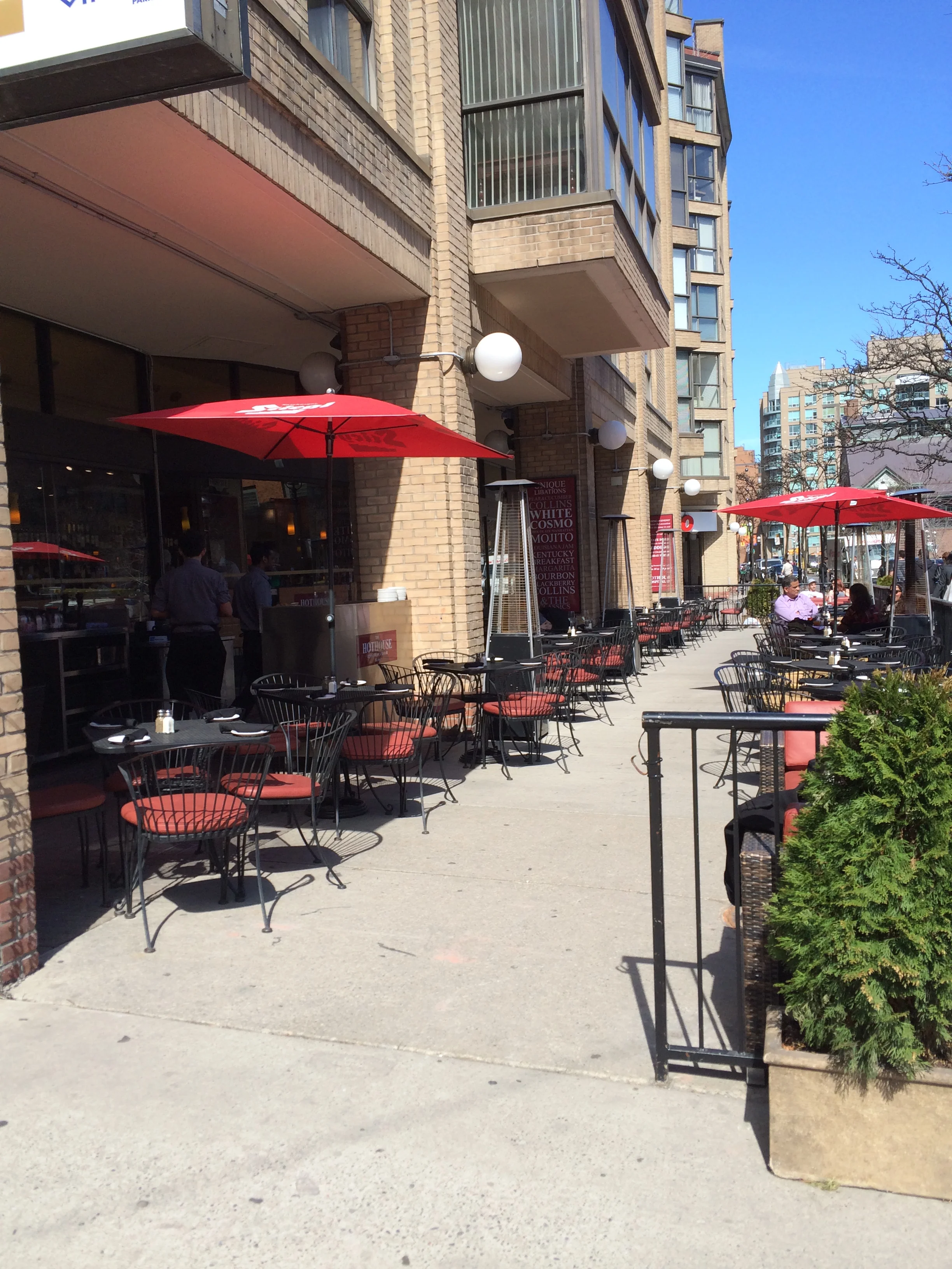 Picture of accessible patio. Red umbrellas.