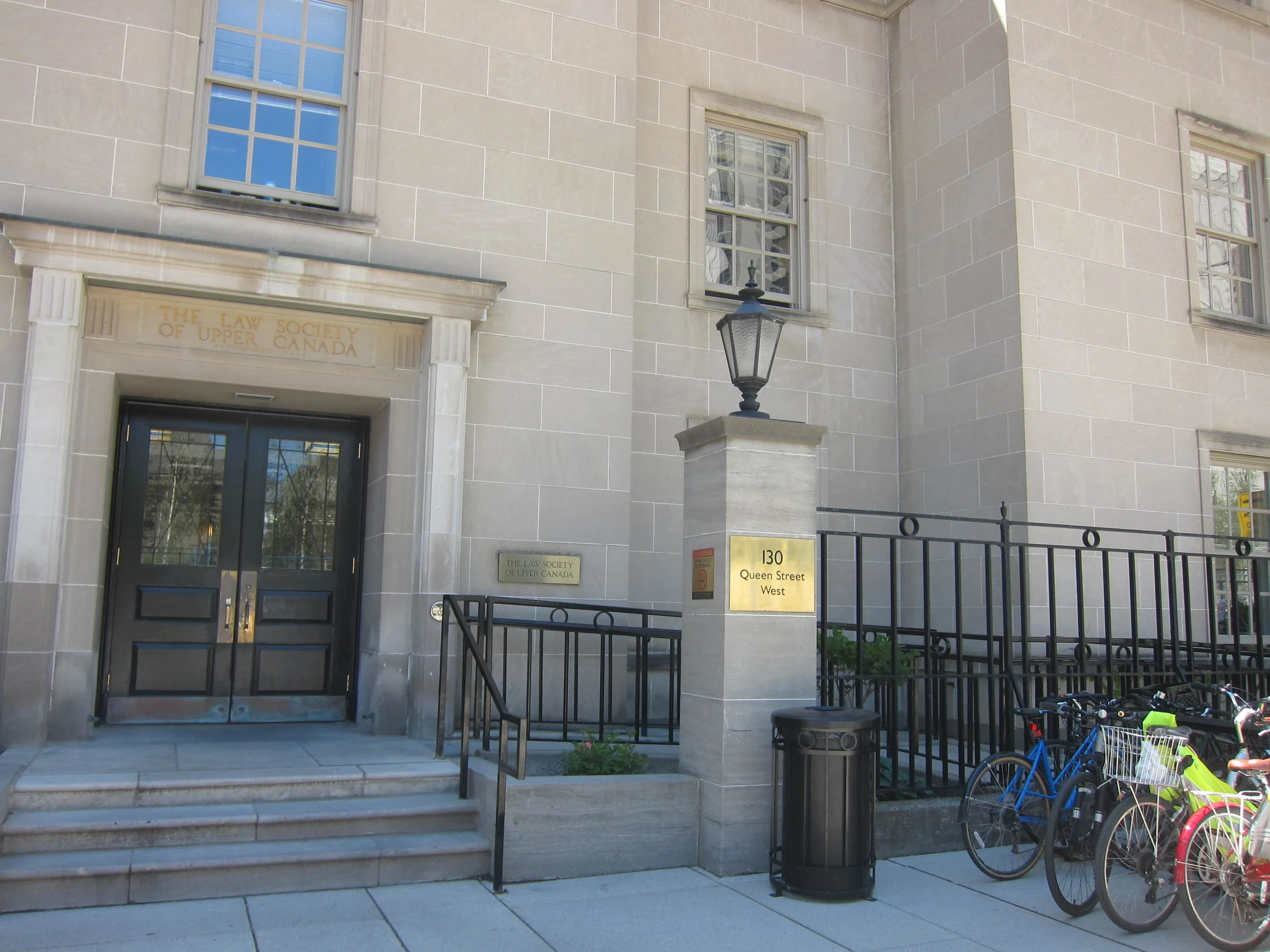 Picture of exterior of building. Ramp to entrance from right.