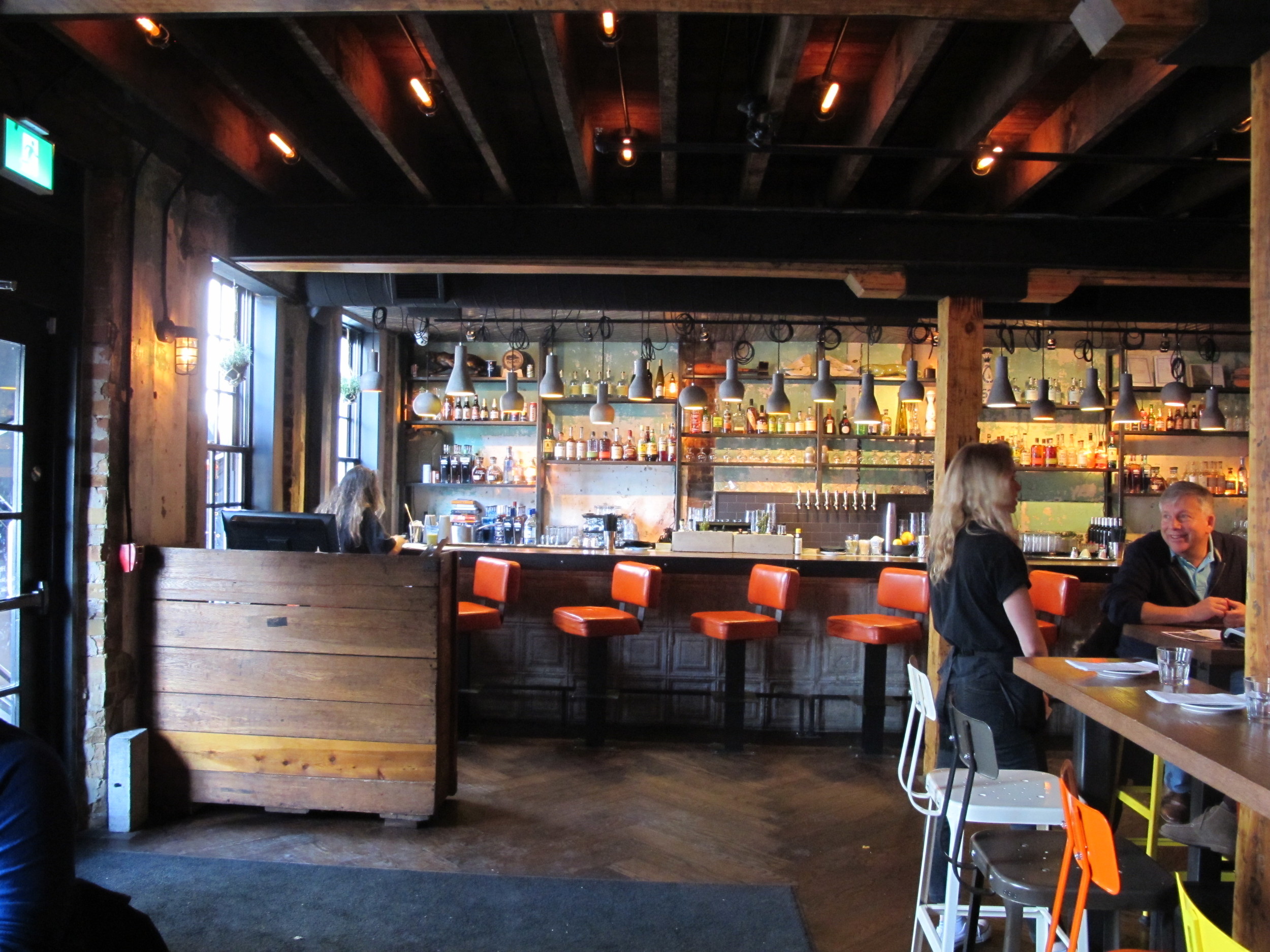 Picture of the main floor dining area. Orange bar height stools featured