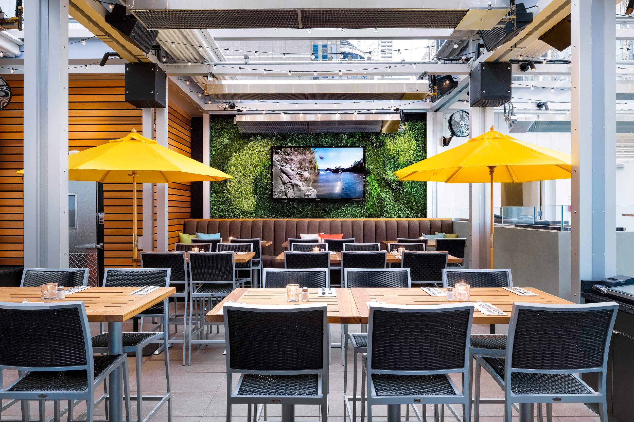 Picture of the deck dining room with yellow umbrellas