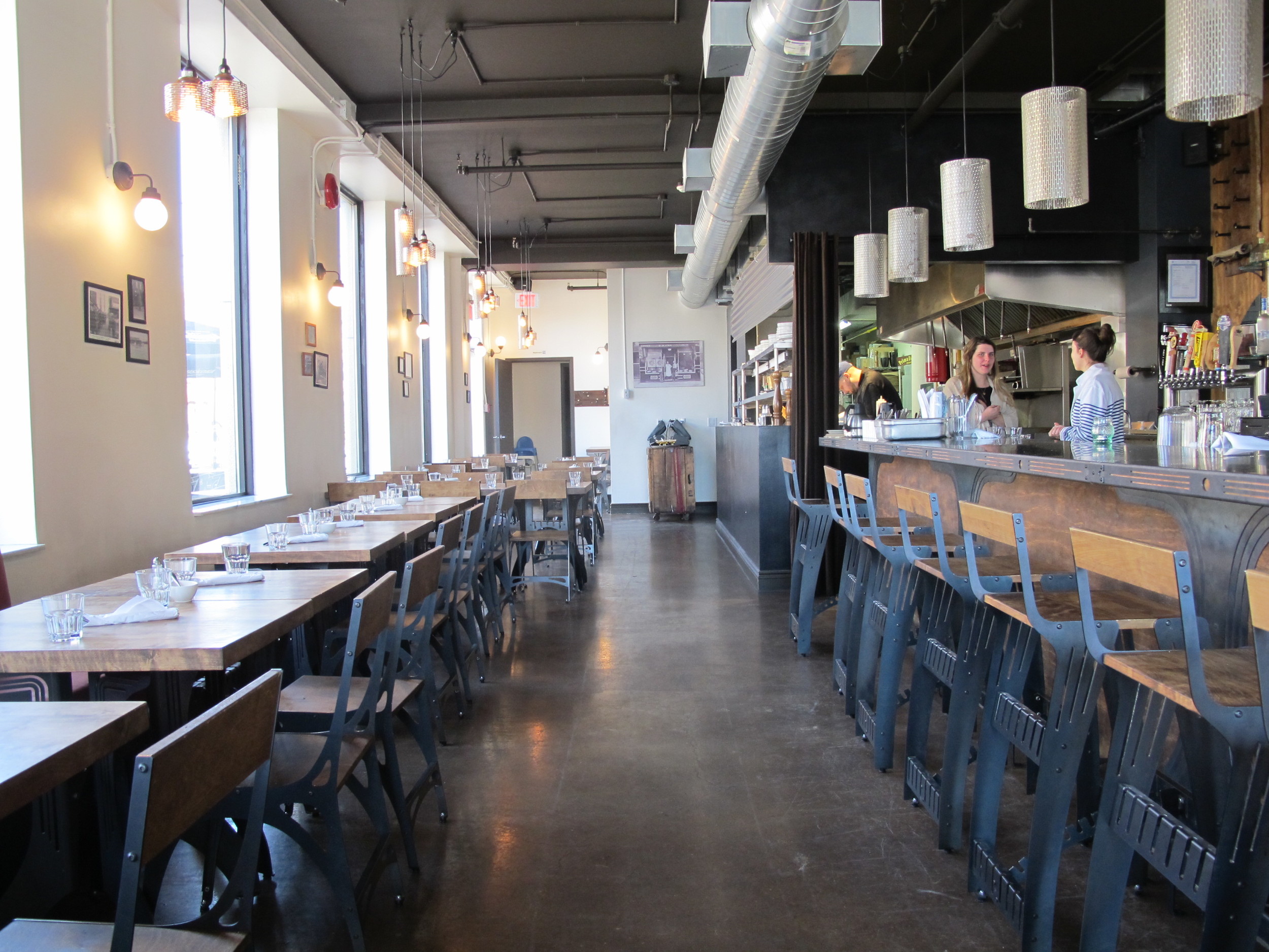 Picture of spacious, accessible interior. Several tables displayed at standard height