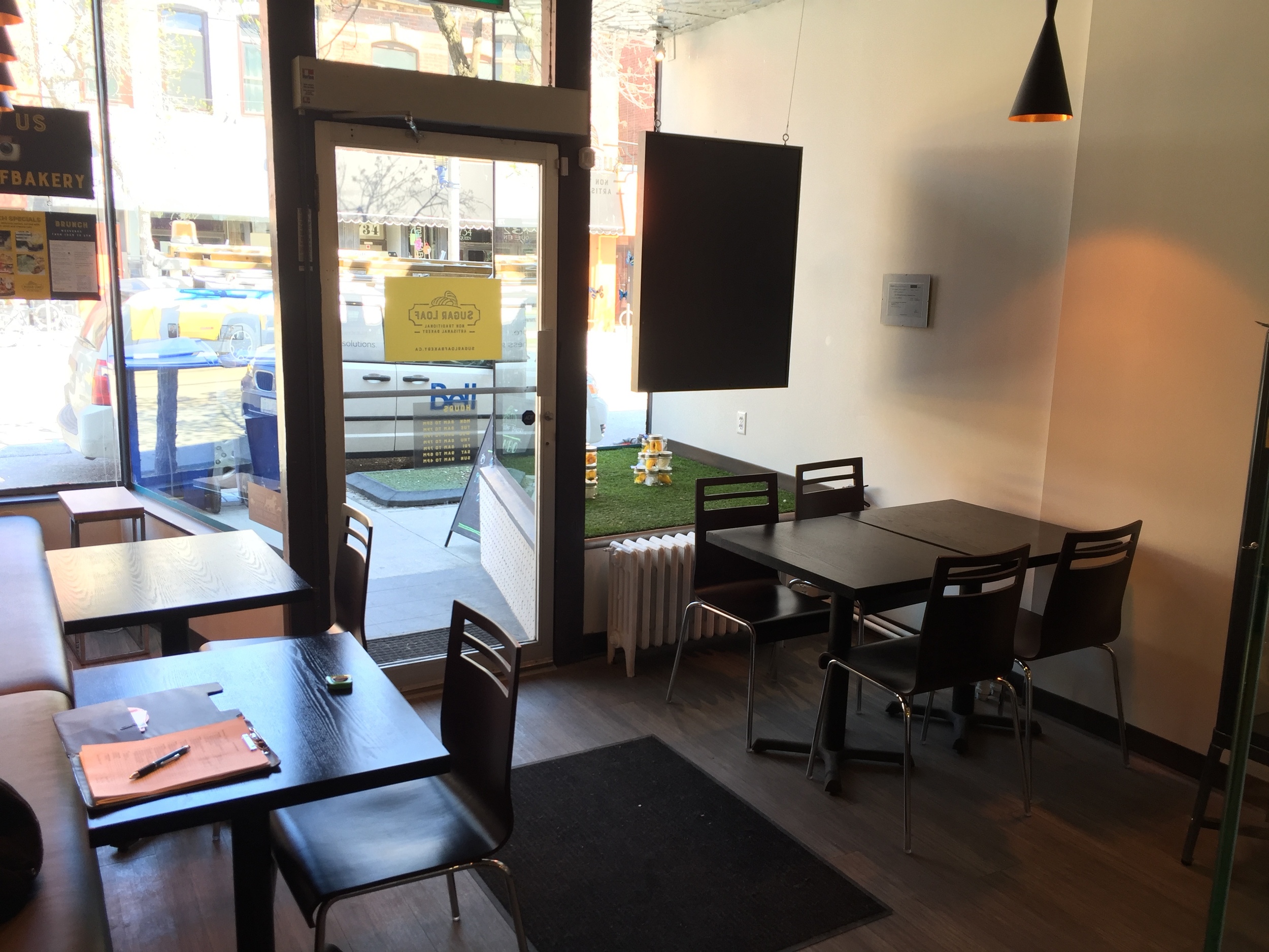 Picture of entrance from the inside. Three standard height tables displayed