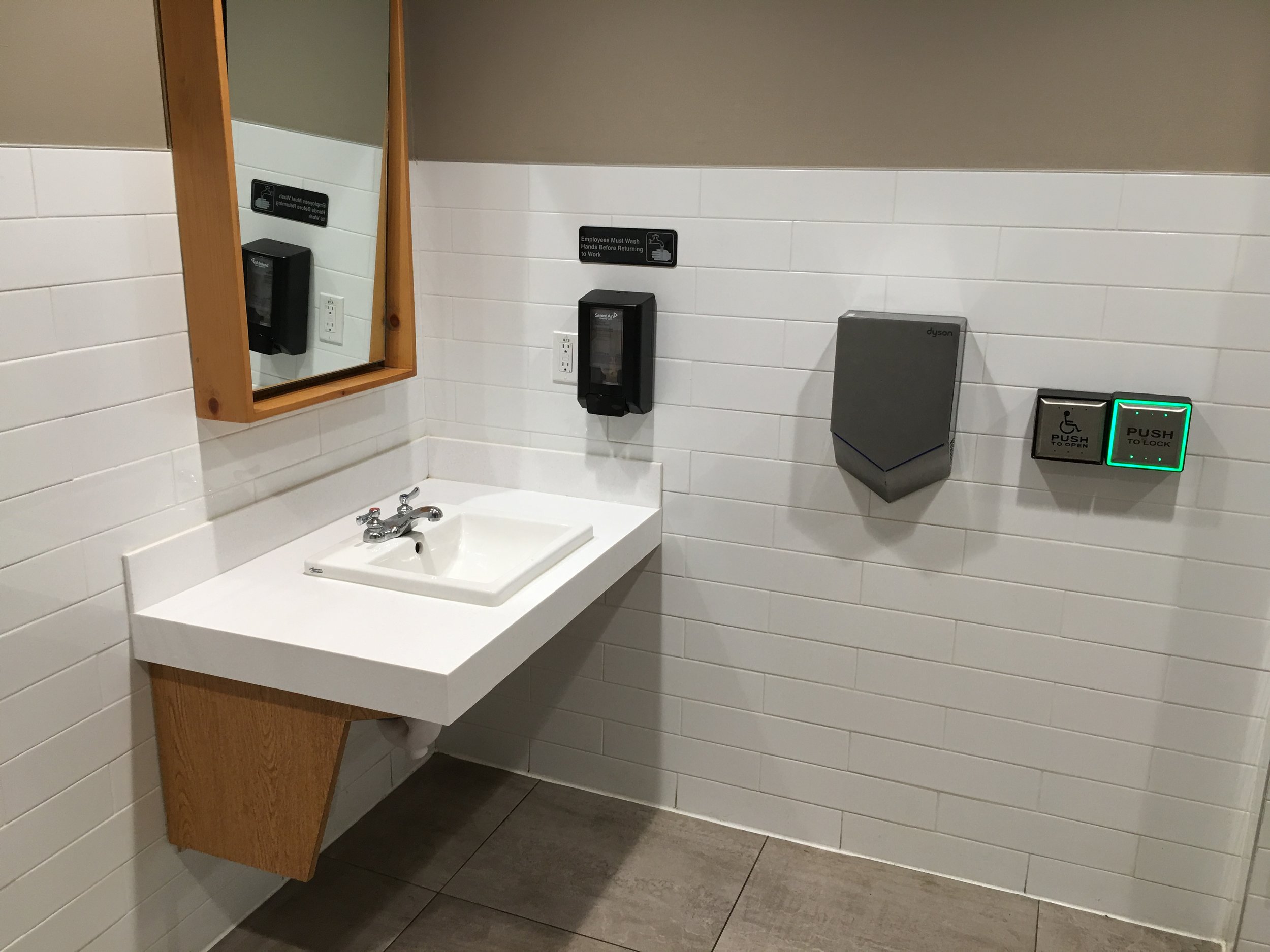 Picture of unobstructed sink and automatic dryer in the washroom