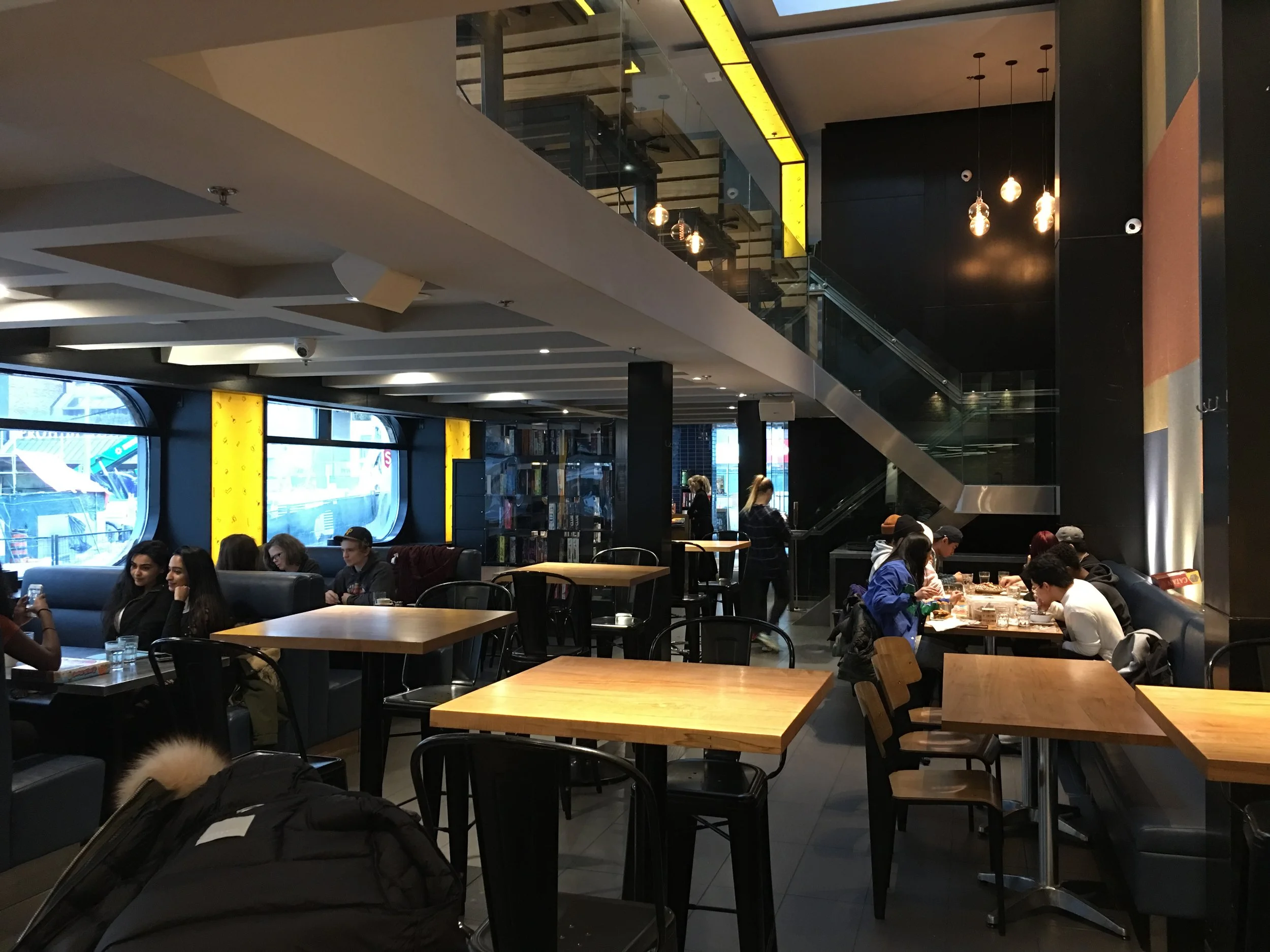 Picture of the interior tables and staircase leading to second floor