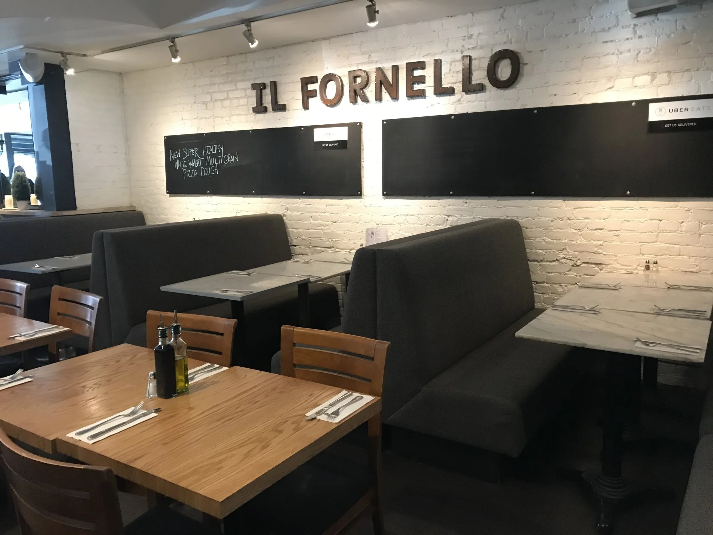 Picture of standard height table and booth seating at Il Fornello