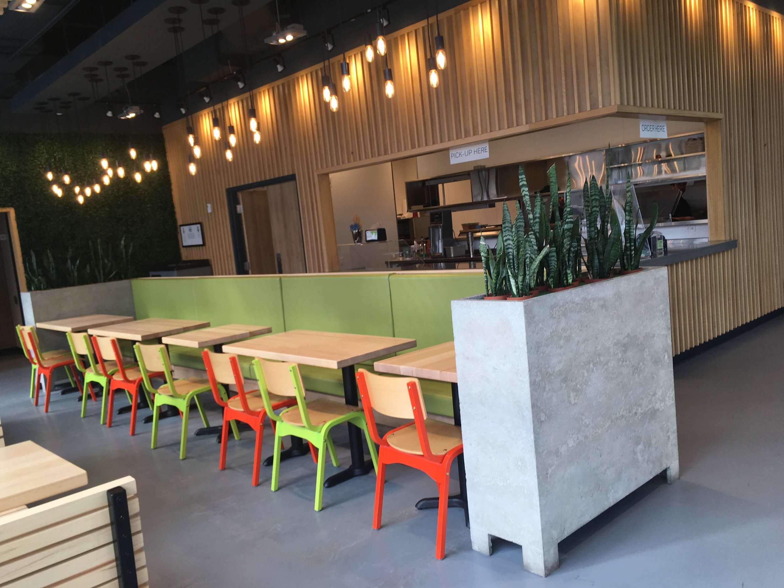 Picture of standard height tables and colorful chairs at Burgers Park
