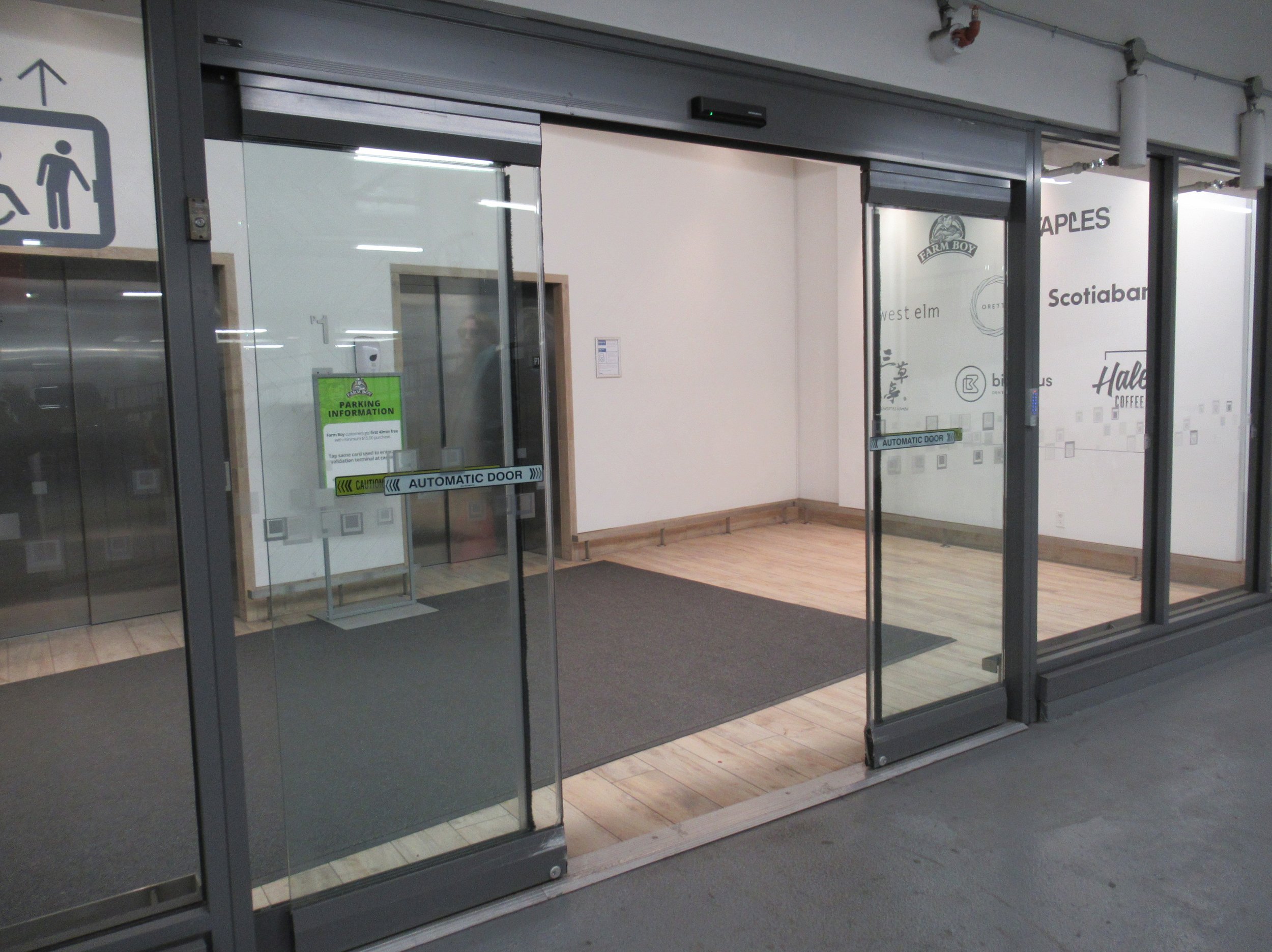 Automatic sliding doors leading you to the elevators to access the second floor