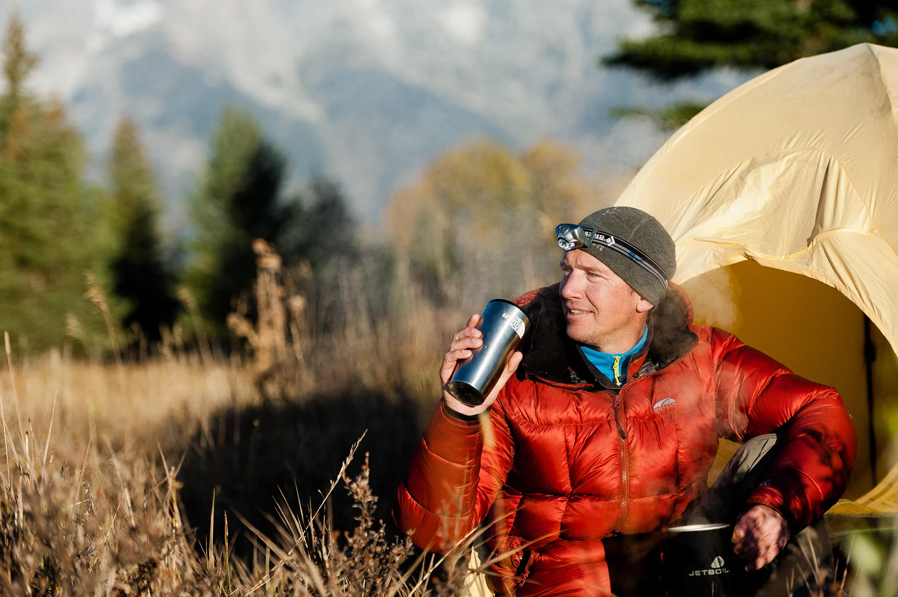 A morning lifestyle advertising image of a camper in Wyoming