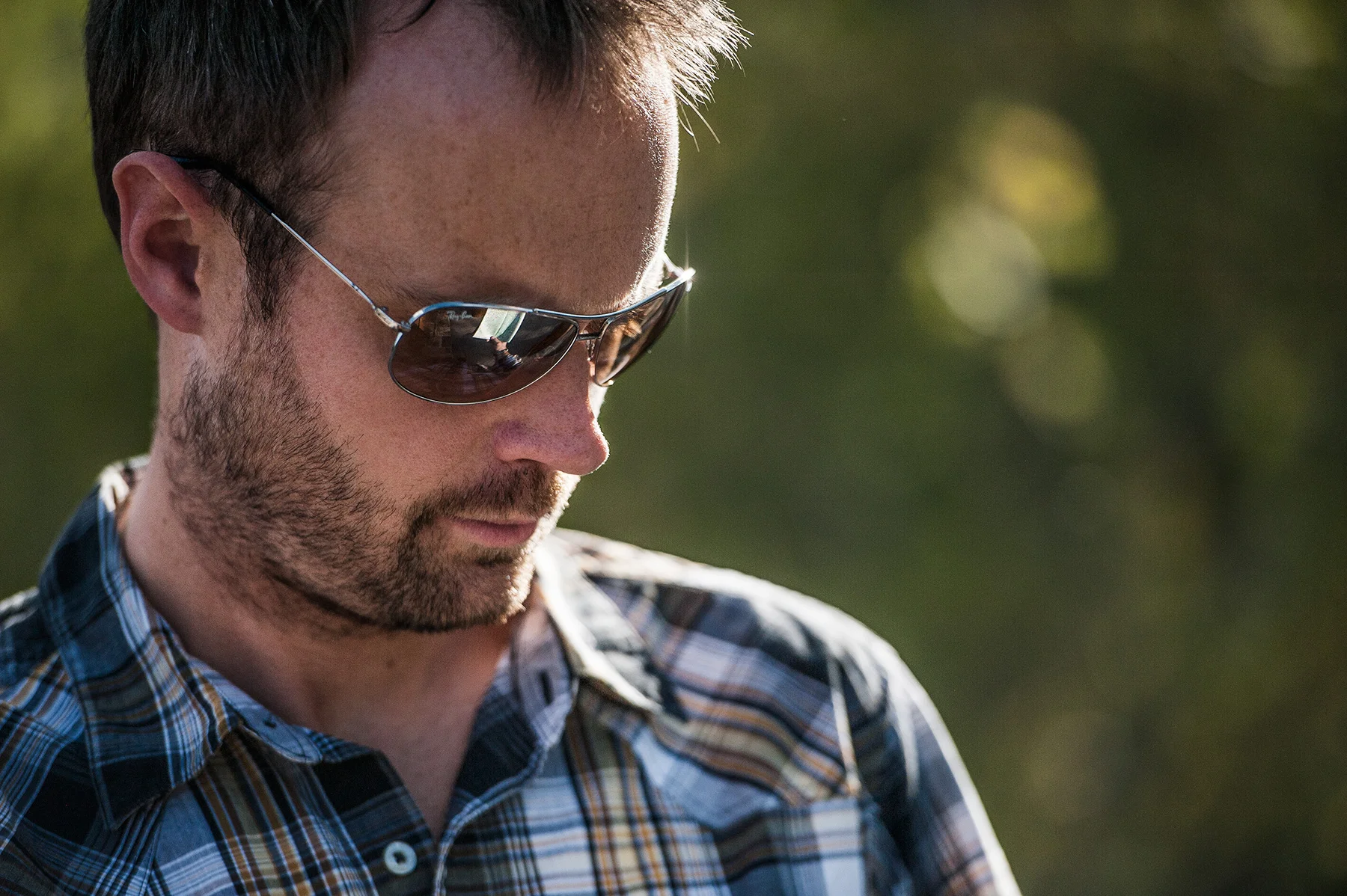 Lifestlye advertising image featuring aviator style sunglasses