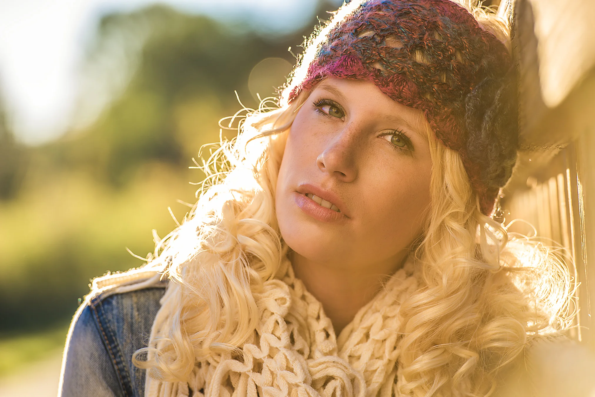 Fashion advertising photo of a teenage girl in a handmade headband and scarf during sunset