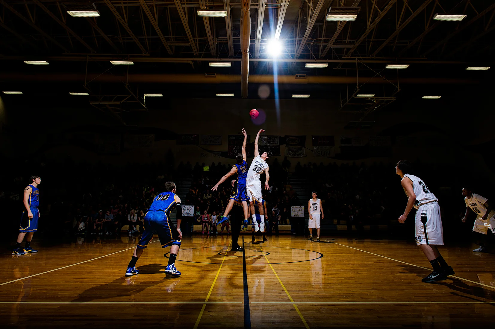 Creative arena lighting at the tipoff of a high school basketball playoff game