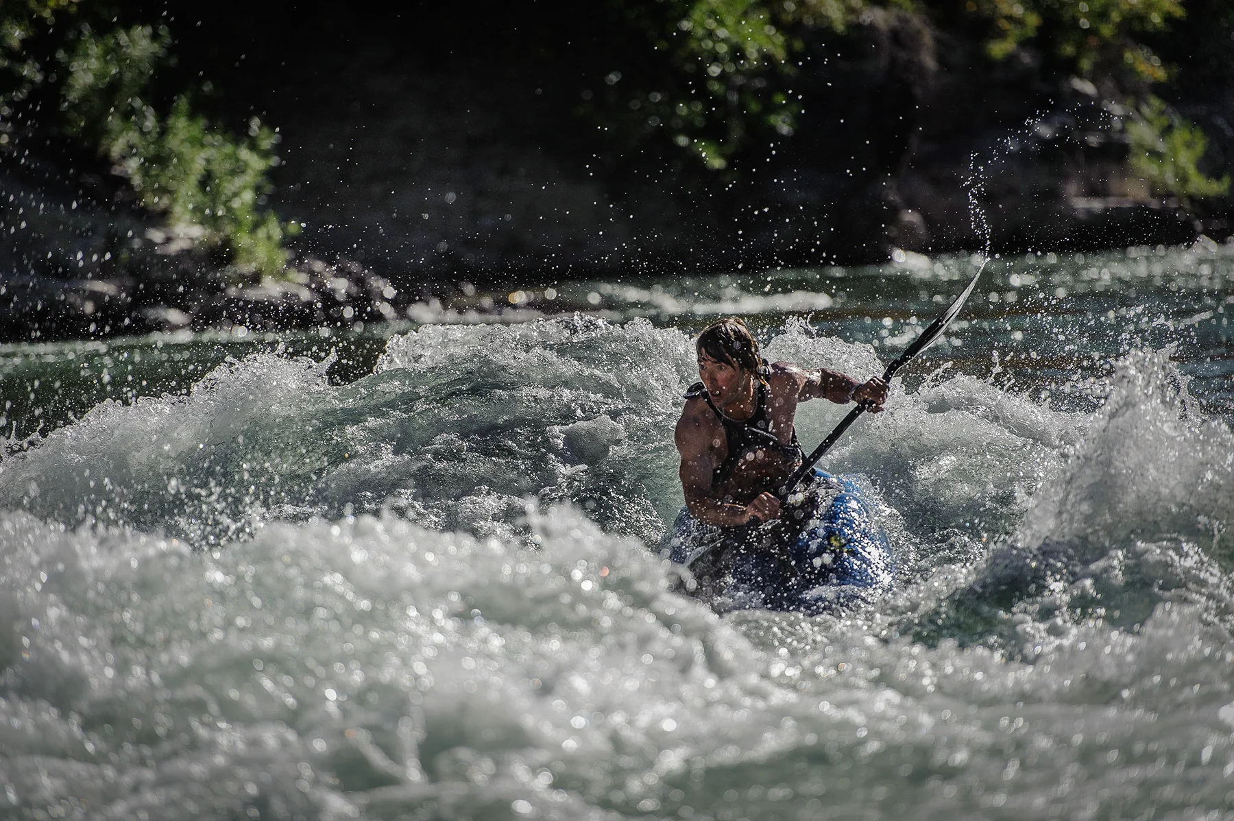 A kayaker plunges into rough waters in a hard stretch of the Snake River in Wyoming