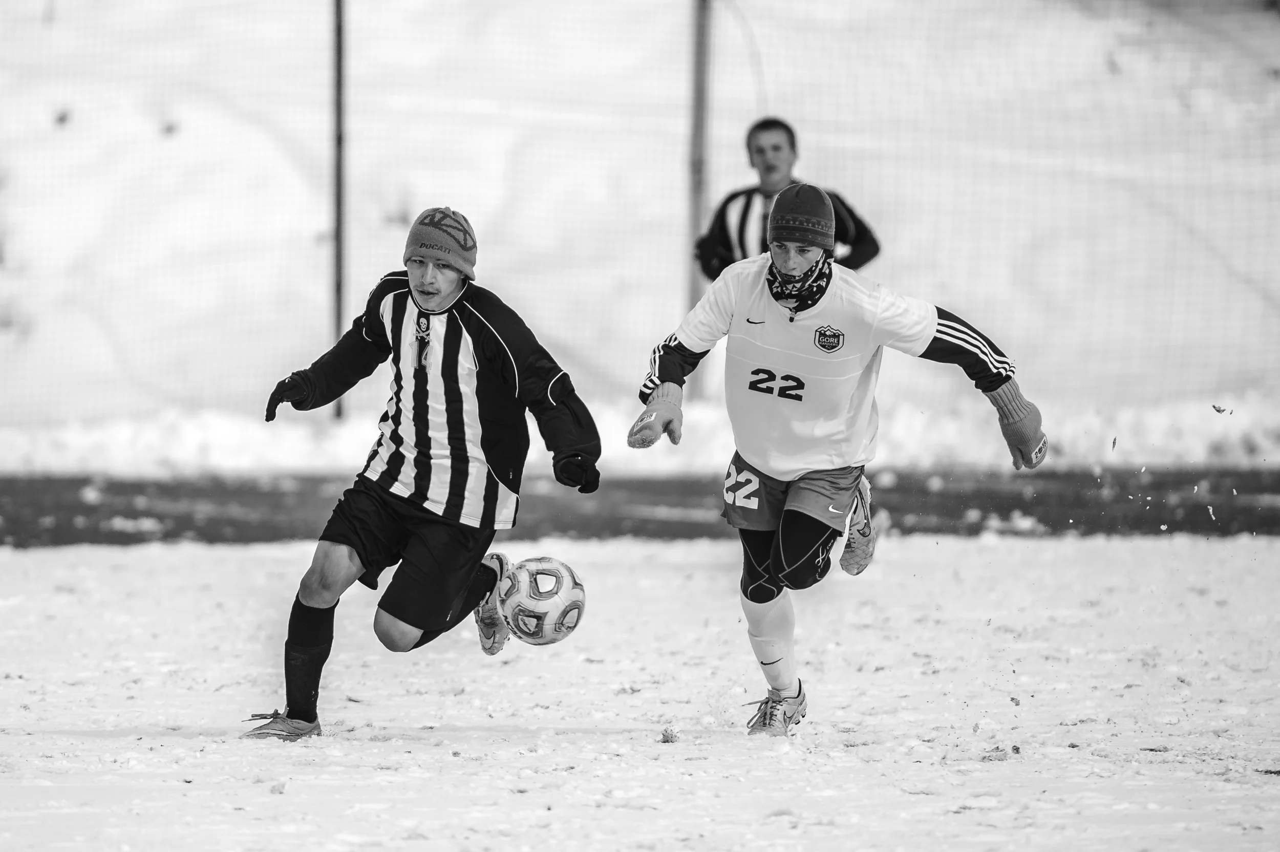Players battle each other and the elements during a playoff soccer game