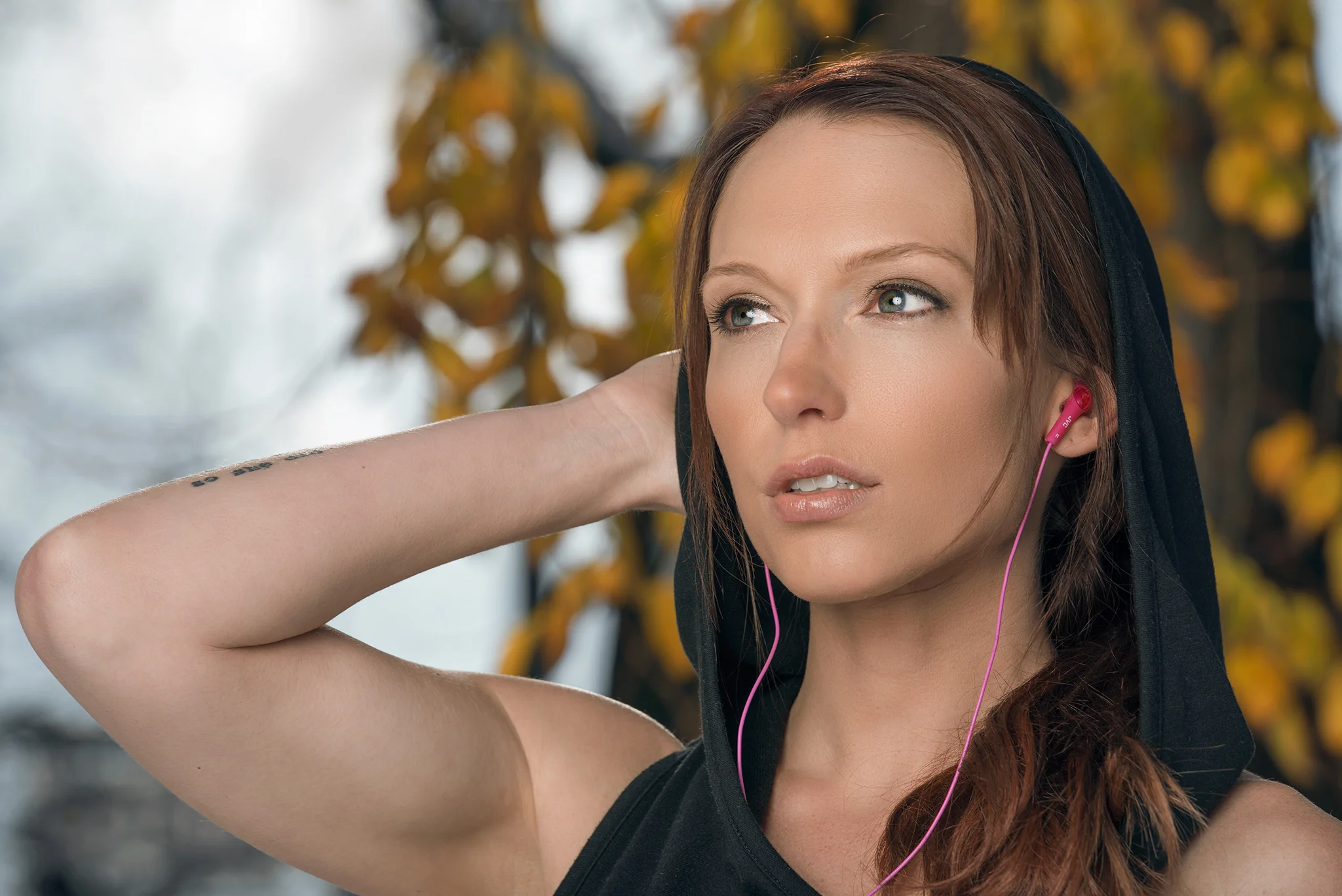 Portrait of female fitness model with JVC headphones