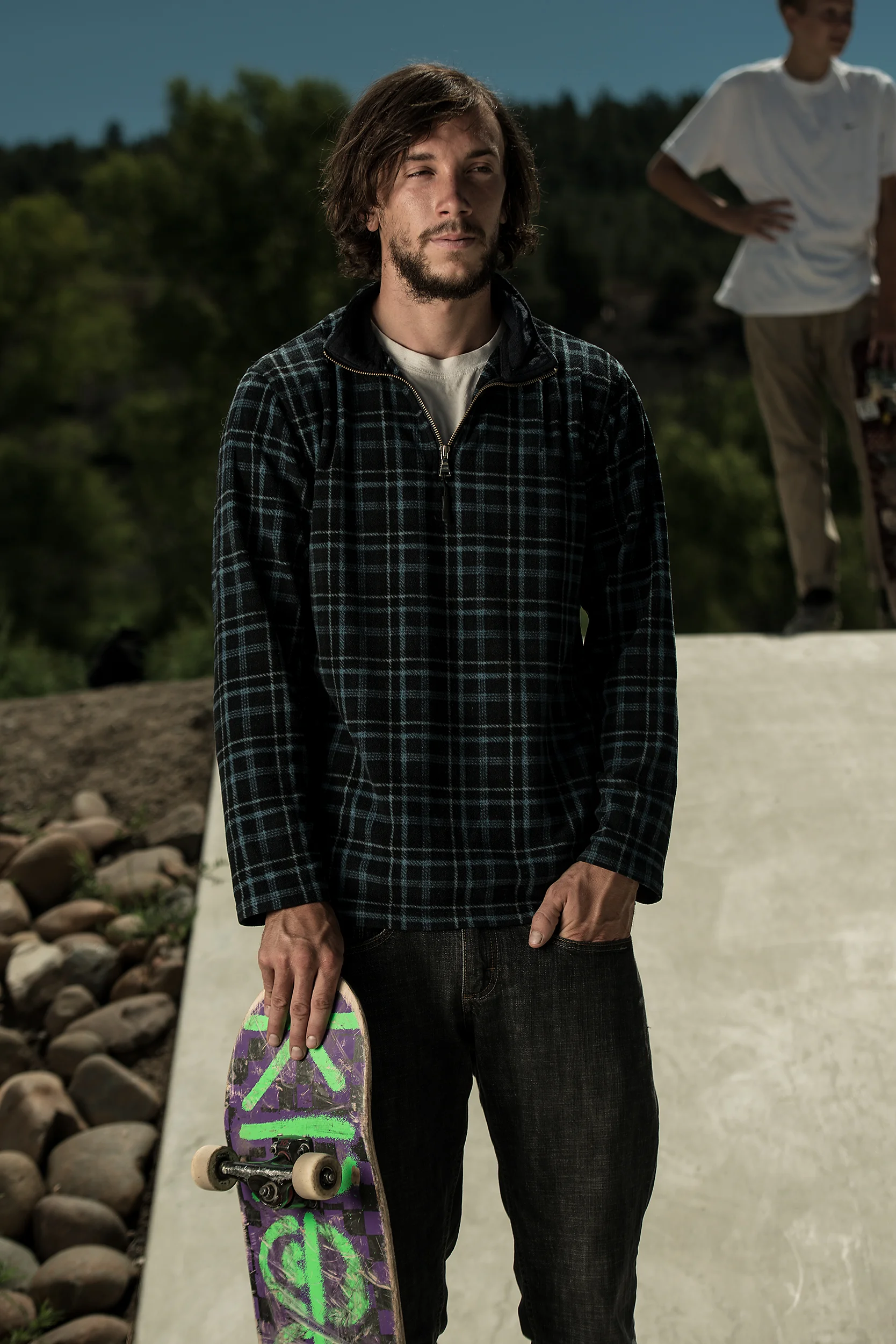 A skateboarder pauses during a small competition for a portrait