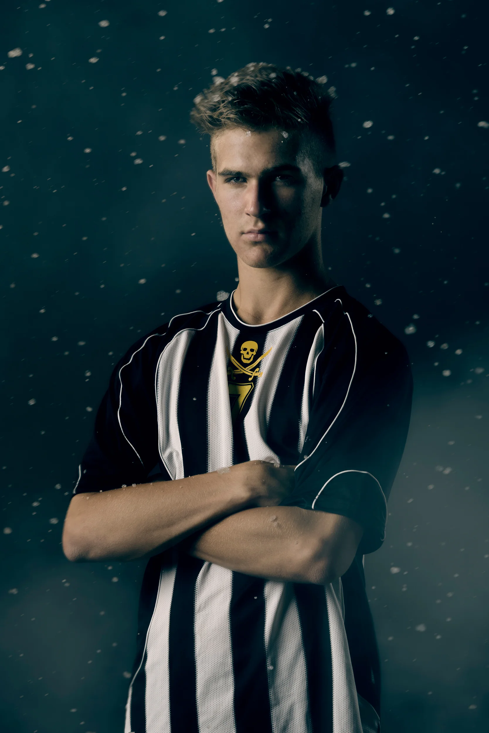 Male soccer player portrait with snow and fog