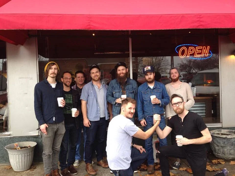 (L to R) Peyton Rodeffer of The Settled & Wilderness Alive, Phill Thompson of the Tombigbees, Craig Higgins of Lunar Lake, Alex Ingram of Lunar Lake & Cory Taylor Cox, Brady Gomillion of Cory Taylor Cox & Daniel Elias + the Exotic Dangers, JW Teller, Taylor McMillen of Lunar Lake, Cory Taylor Cox, Chris Heaton of Lunar Lake, in front of Rivertown Coffee Florence AL