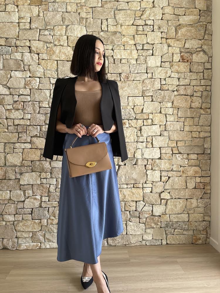 Wendy Russell is black jacket and blue skirt