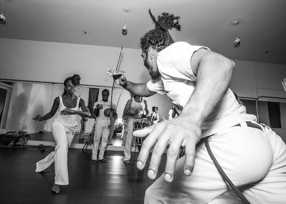 Students spend years learning how to do the first, basic movement of Capoeira, which is the Ginga (or swing), which Pena can be seen teaching a white chord (or beginner) how to do above. (Photo by Ace Murray / Brooklyn Juice Photography .)