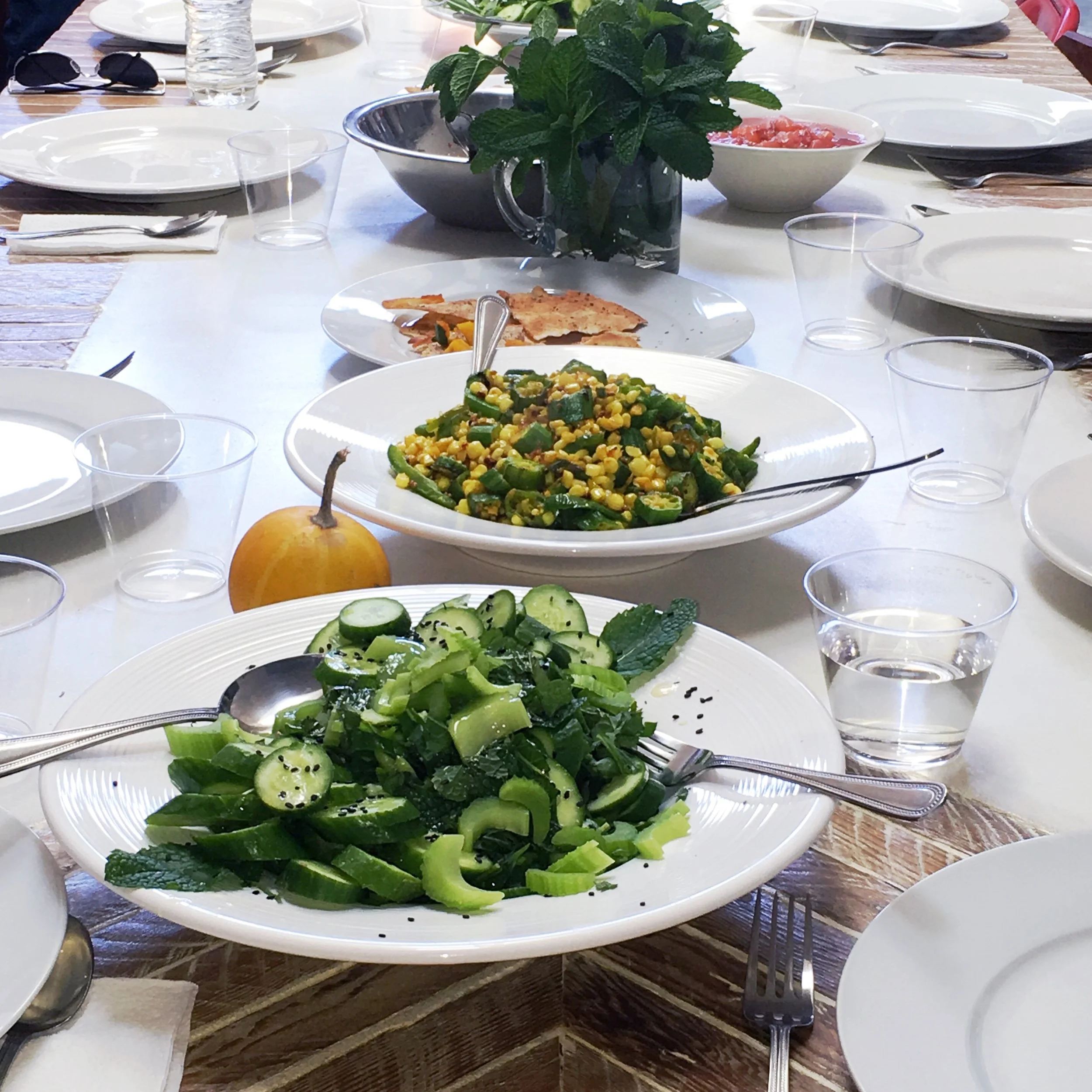 Salad with Persian cucumbers, celery and mint. Side dish with corn, okra, and spices