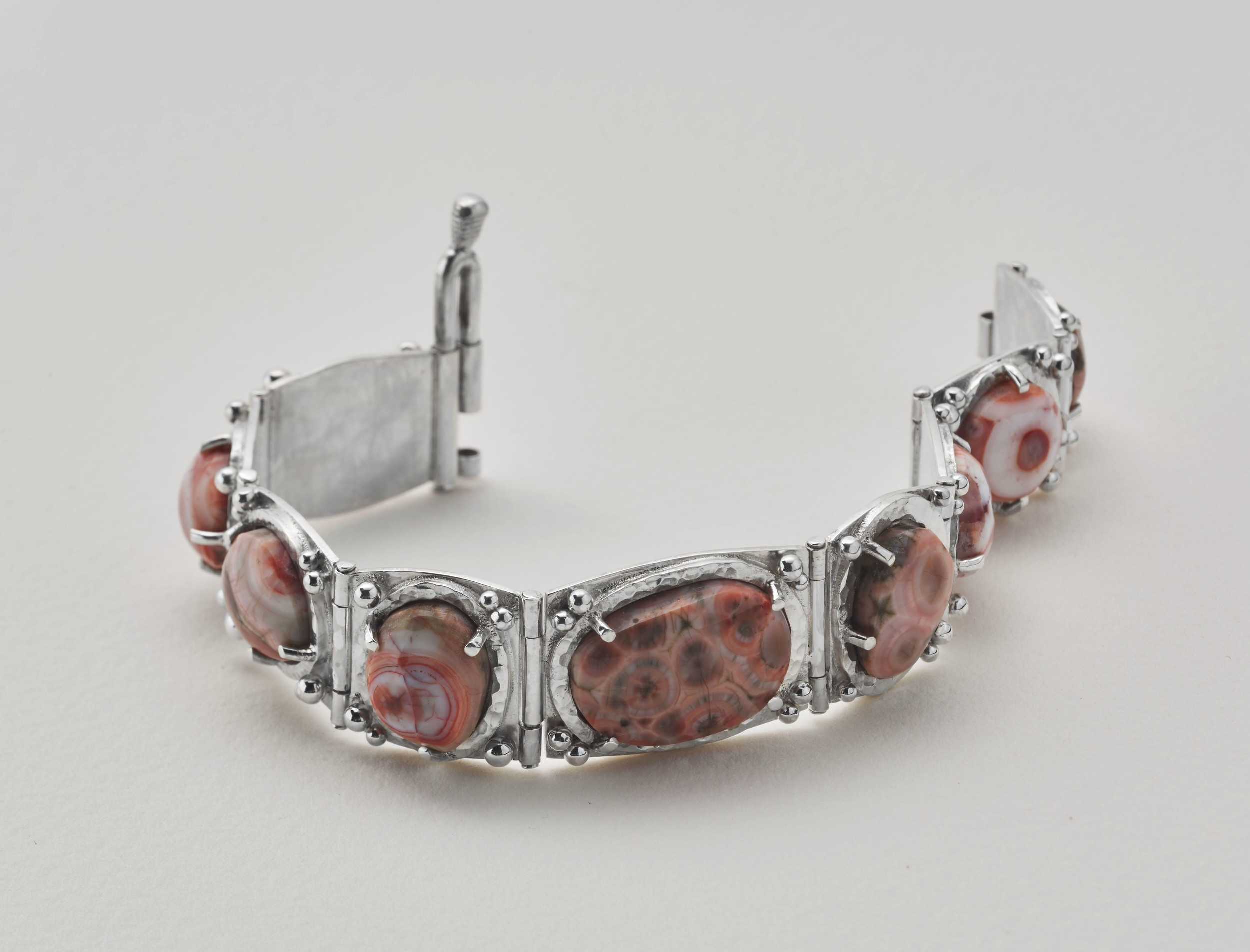Thomsonite cabochons from Grand Marais, Minnesota. Set in a sterling silver articulated bracelet.