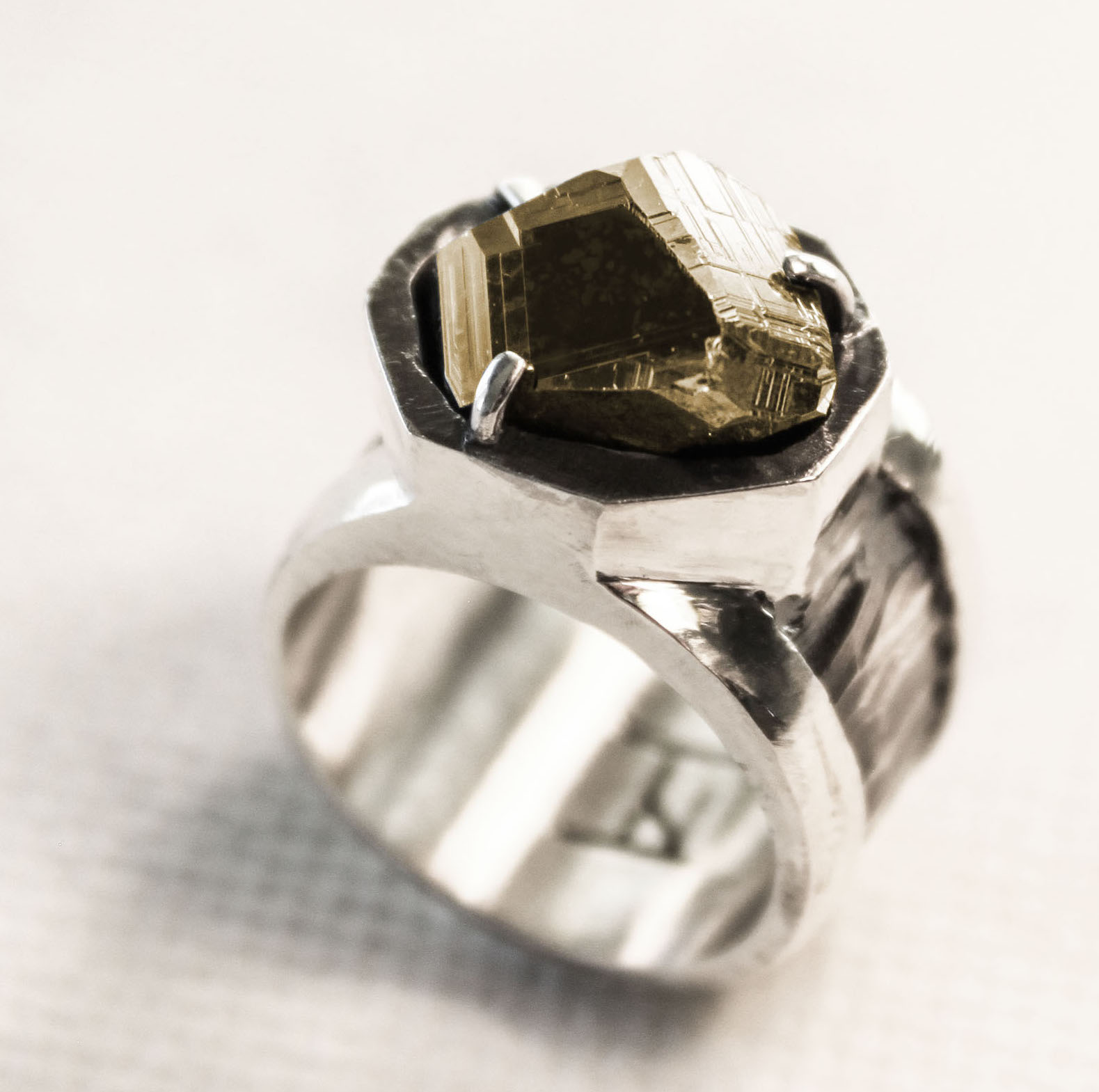 Pyrite crystal from Spruce Ridge, Washington set in a casted sterling silver ring. This crystal displays distinct striations from crystal form modifications.