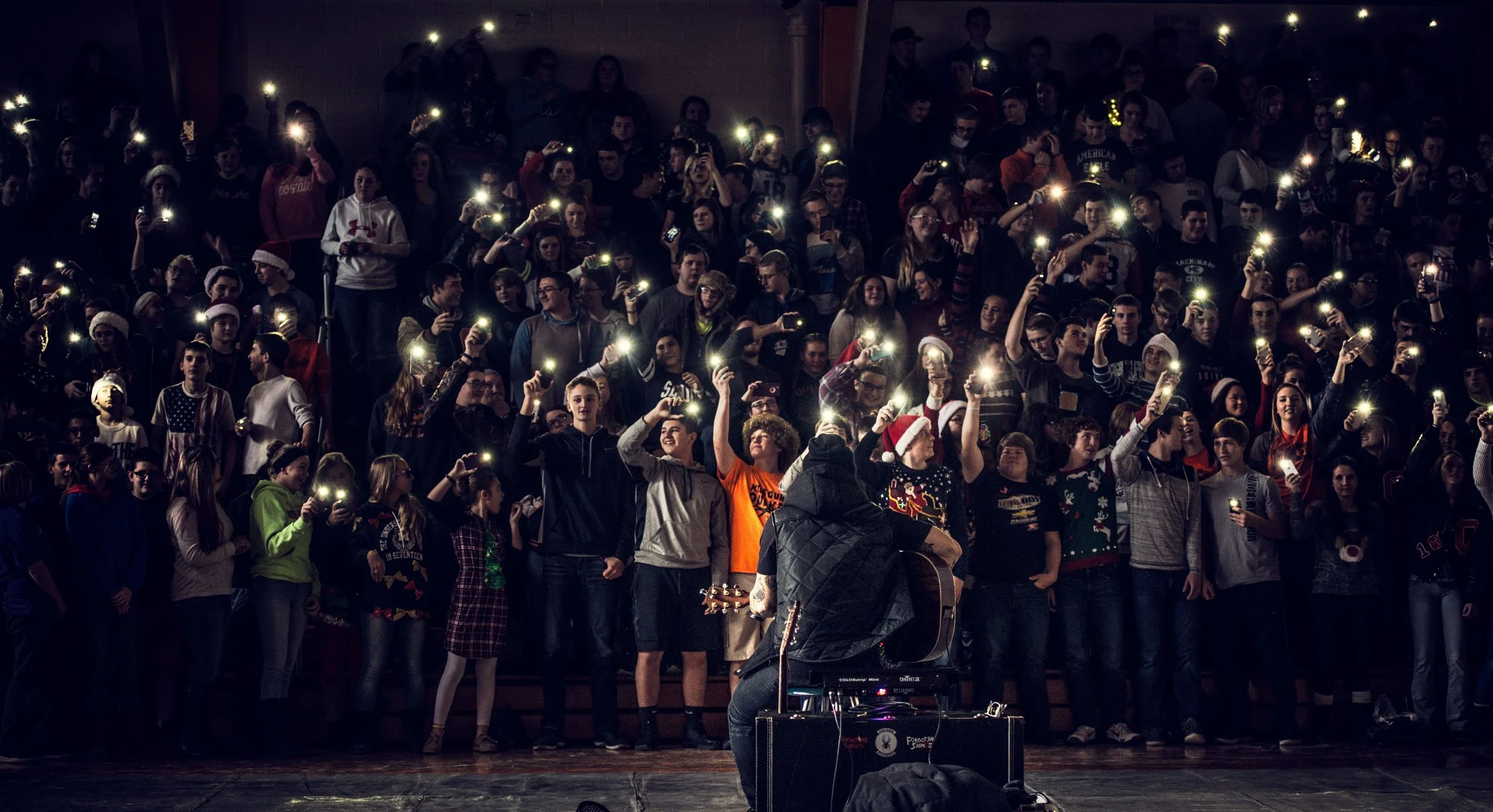 Jared performing at a school through his youth program, Live To Be