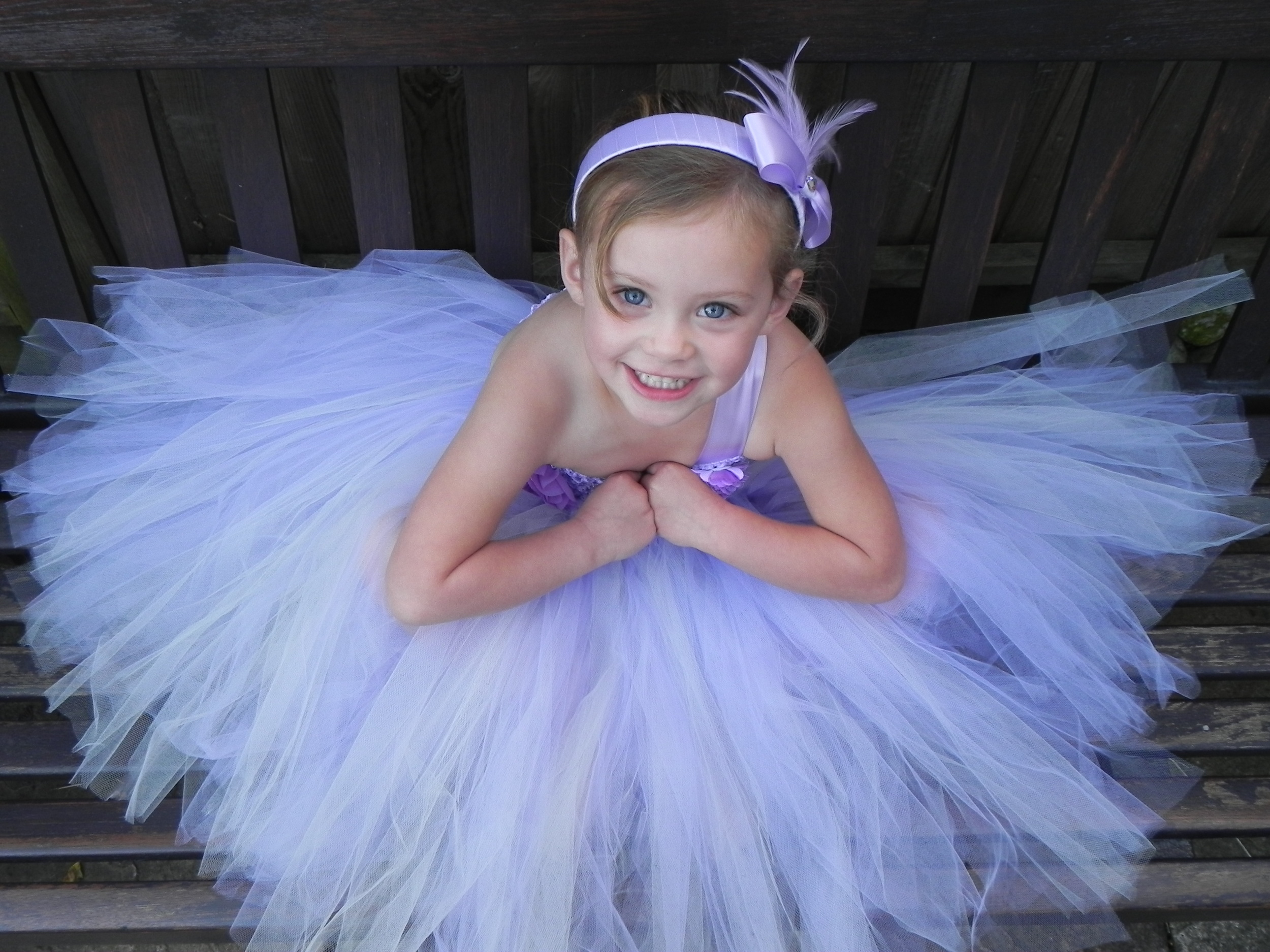 Lavender: Lilac crochet top with alternating light purple and dark purple layers decorated with fabric flowers and crystals. Headband made to order.
