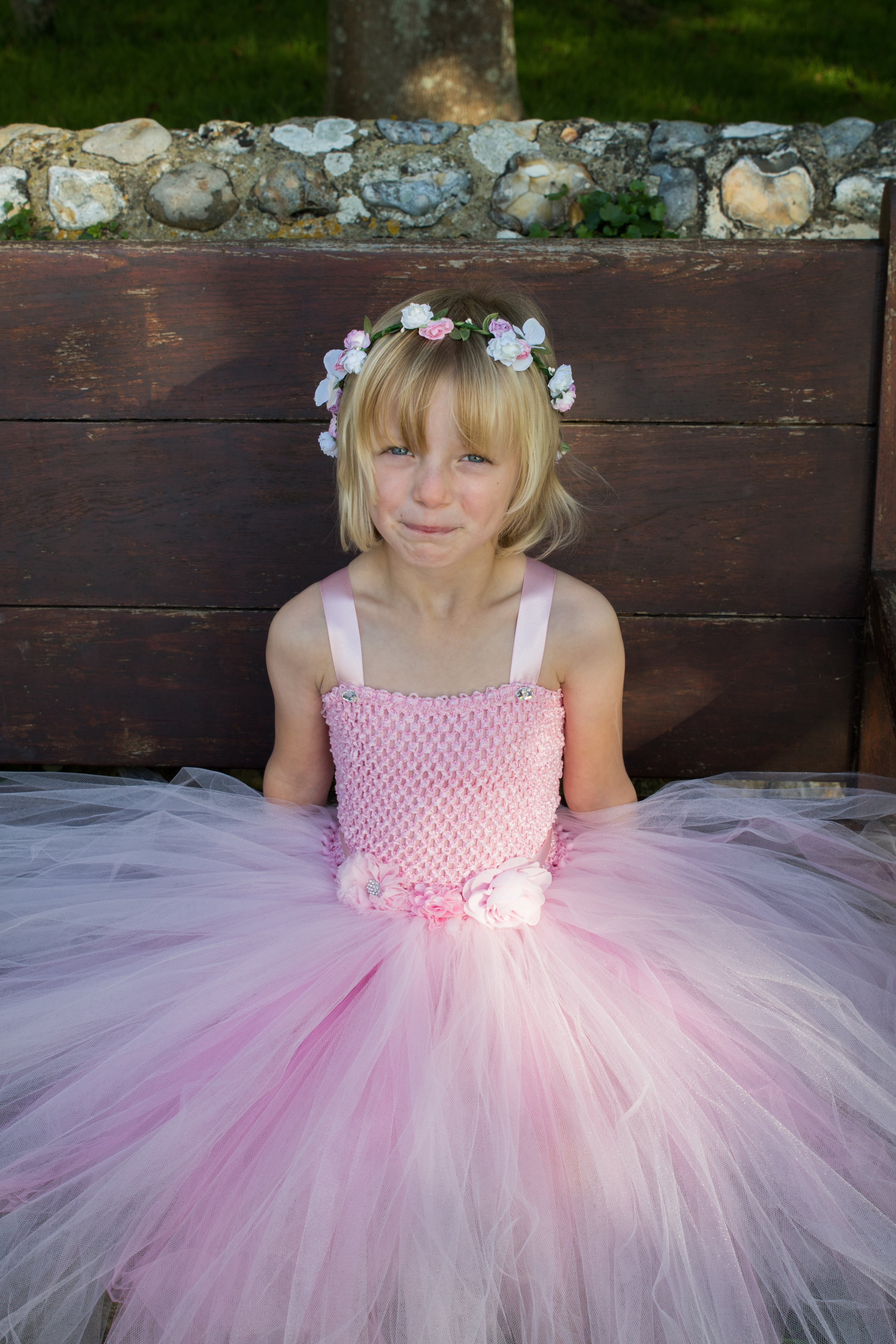 Rose: Pink crochet top with alternating light pink and dark pink tulle layers. Decorated with various fabric flowers.