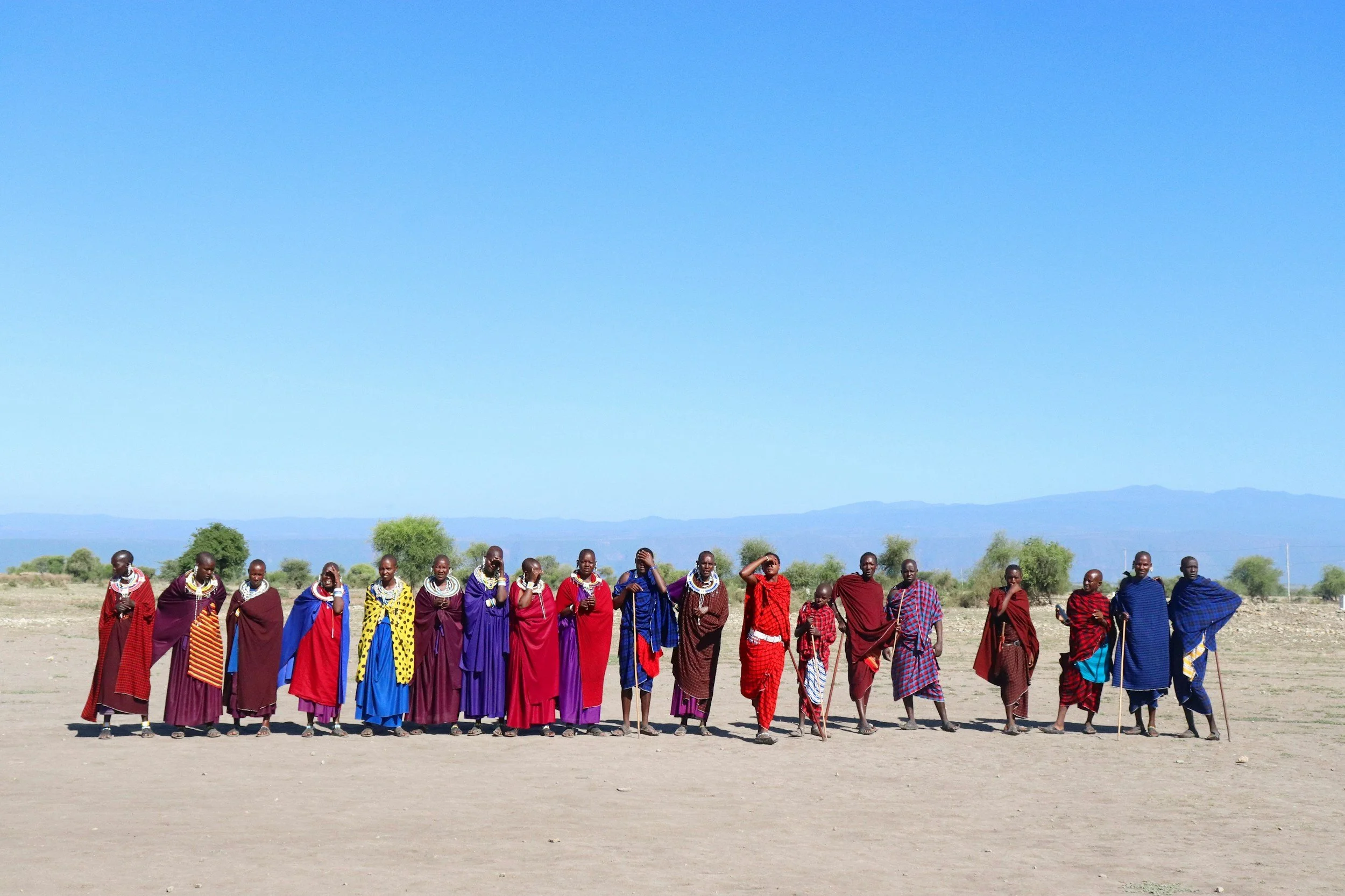 Members of the Maasai tribe lined up on the dry deserted plains in Tanzania