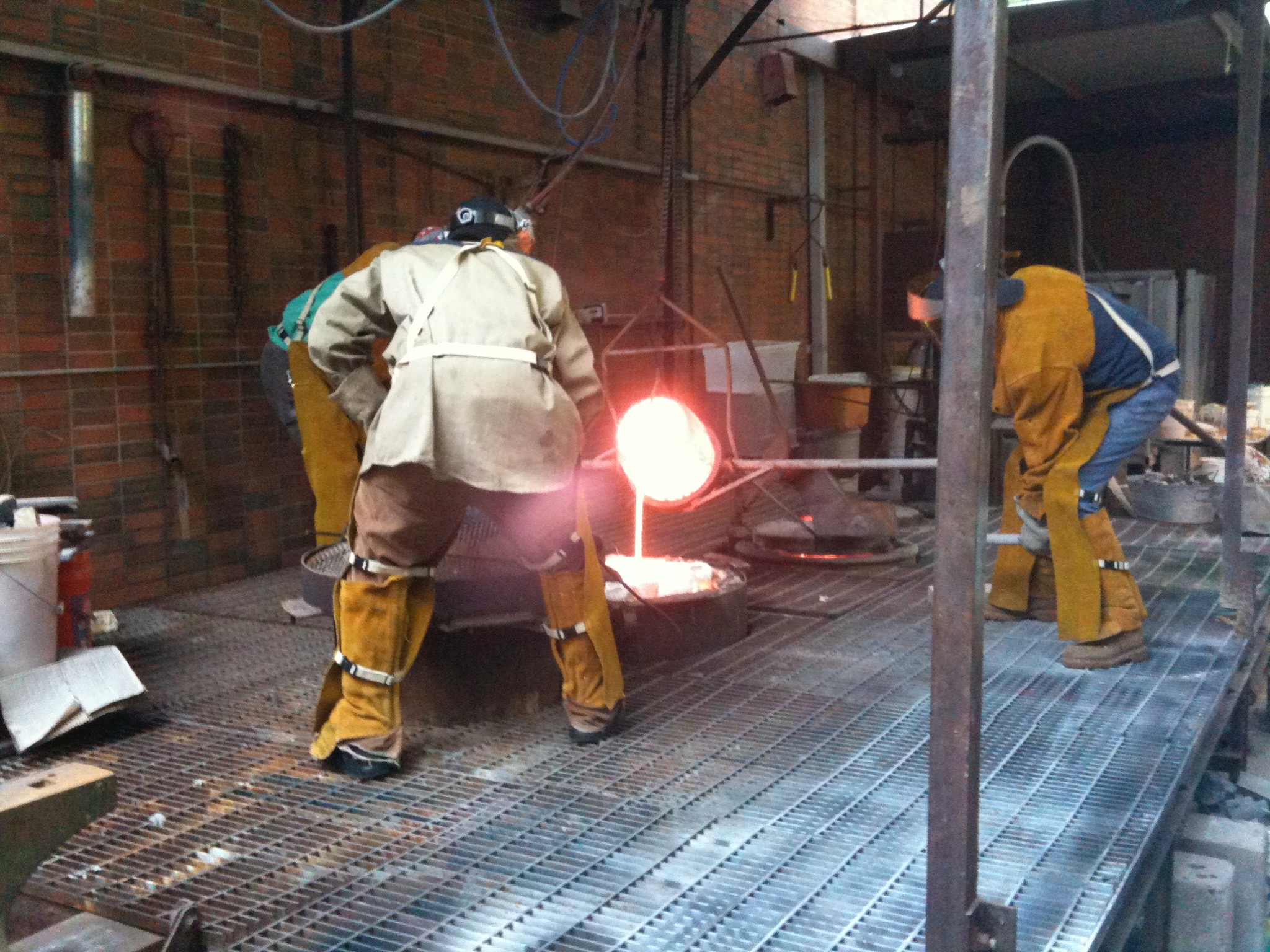 Sculpture was by far the most terrifying class I took. We used a ton of tools that could definitely kill you. Here, my professor and his grad students are pouring bronze into a bunch of moulds we made. I still have my sculpture from this bronze casting and it weighs a freaking ton! 